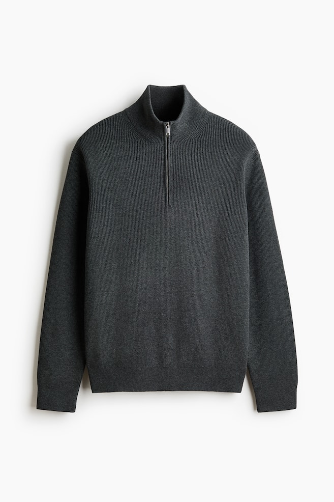 A dark gray quarter-zip sweater is facing forward, featuring a ribbed knit texture, a stand-up collar, a silver-toned zipper, and ribbed cuffs and hem. - 1