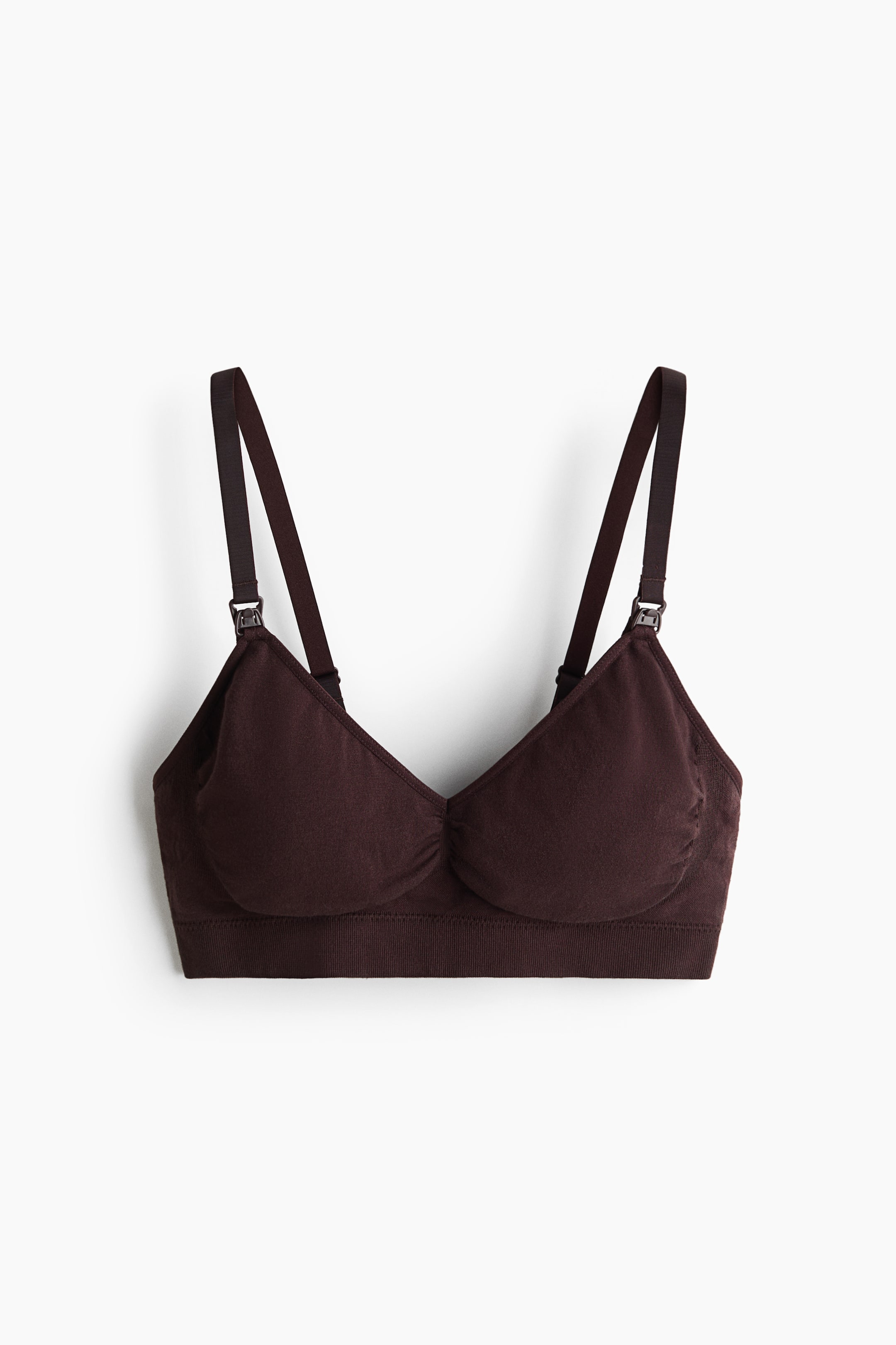 Vis større bilde: En mørkebrun jersey amme-bh vises forfra, med justerbare skulderstropper med ammeklips. Den er designet med sømløse, myke skåler og et bredt, ribbet bånd under.