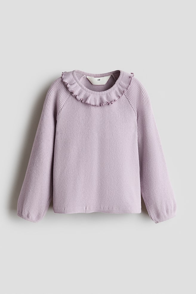 A light purple ribbed-knit top is shown facing front, featuring a round, frill-trimmed neckline and long raglan sleeves with narrow, bound cuffs. - 1