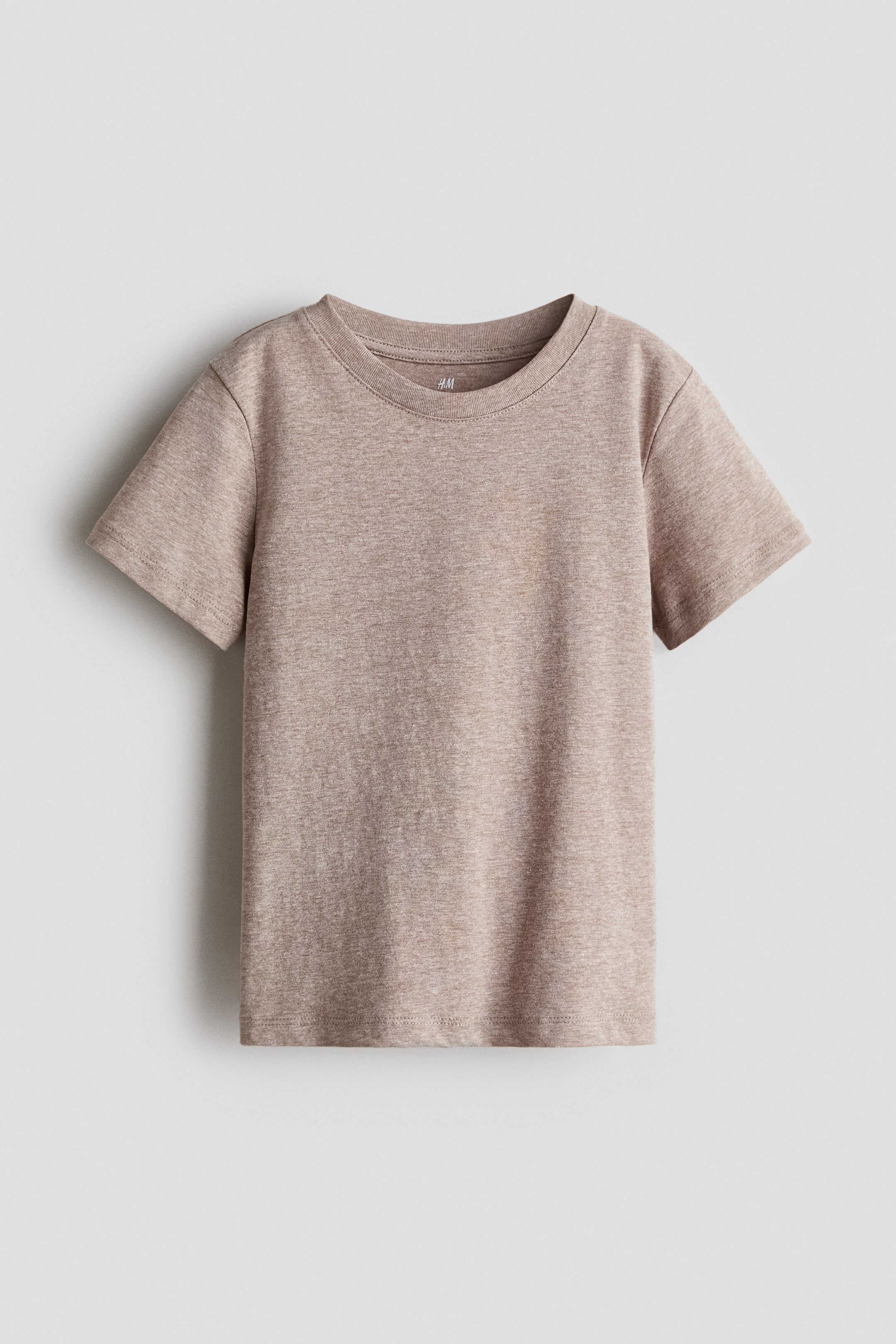 View larger image: T-shirt in soft cotton jersey showcases its front, adorned with a heathered light brown hue. It is crafted with a ribbed crewneck and short sleeves.