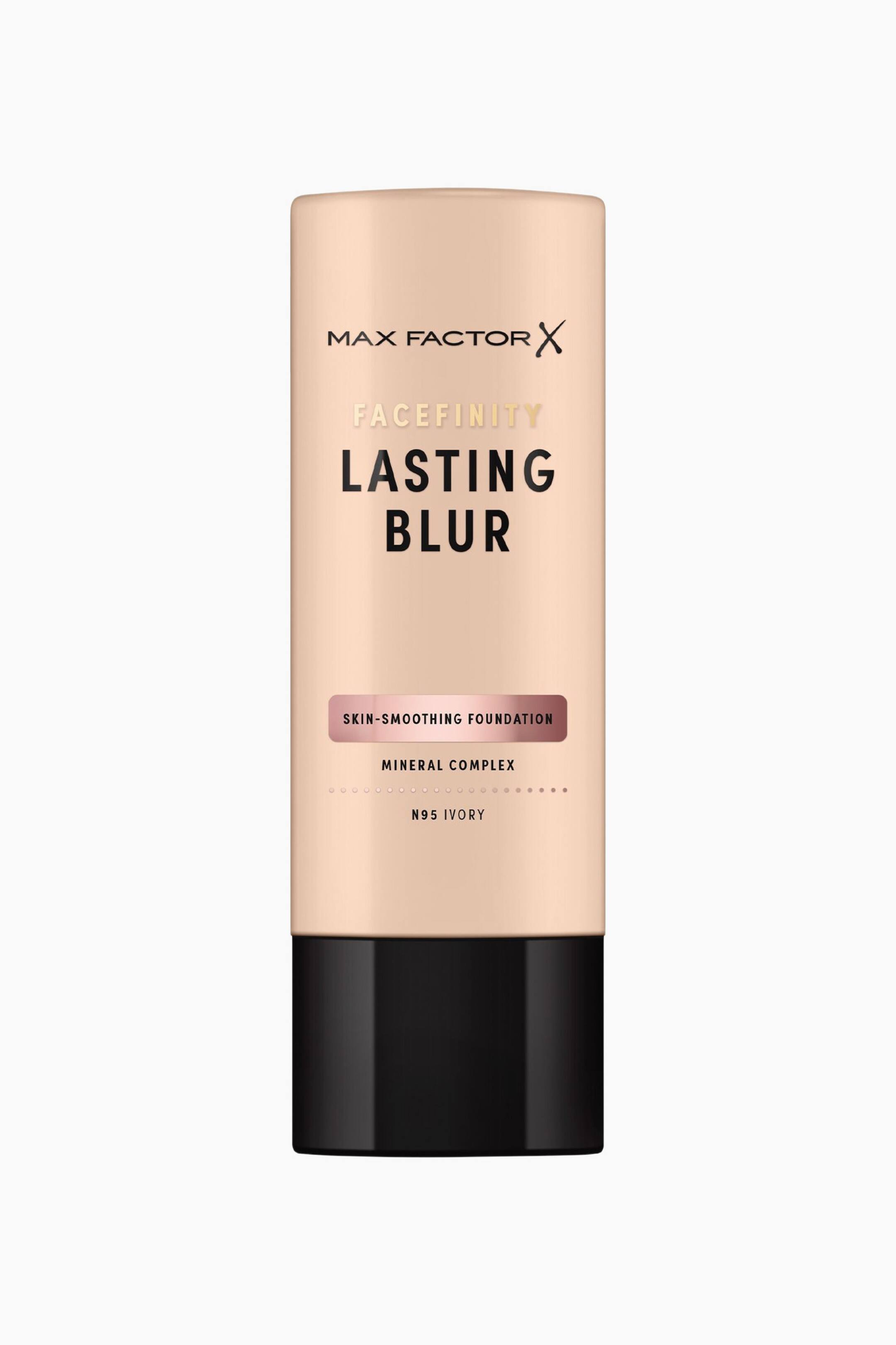 Visa större bild: En flaska Max Factor Facefinity Lasting Blur Foundation står upprätt och vänd framåt. Den cylindriska beige flaskan har en blank svart kork vid basen och visar svart och guldig text, inklusive ett roséguldfärgat metallband med texten "Skin-Smoothing Foundation" samt nyansnamnet "N95 Ivory".