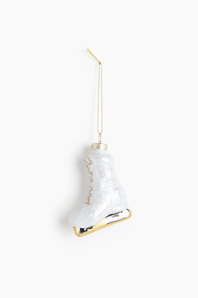 Glass Christmas Ornament - White/skate/Silver-colored/moka pot/Dark beige/croissant/Dark beige/house/Silver-colored/caviar tin/Silver-colored/coffee cup/Red/Hot Cocoa/Gold-colored/cable car/Gold-colored/pompom hat/White/mitten/Gold-colored/skis/Gold-colored/boots - 1