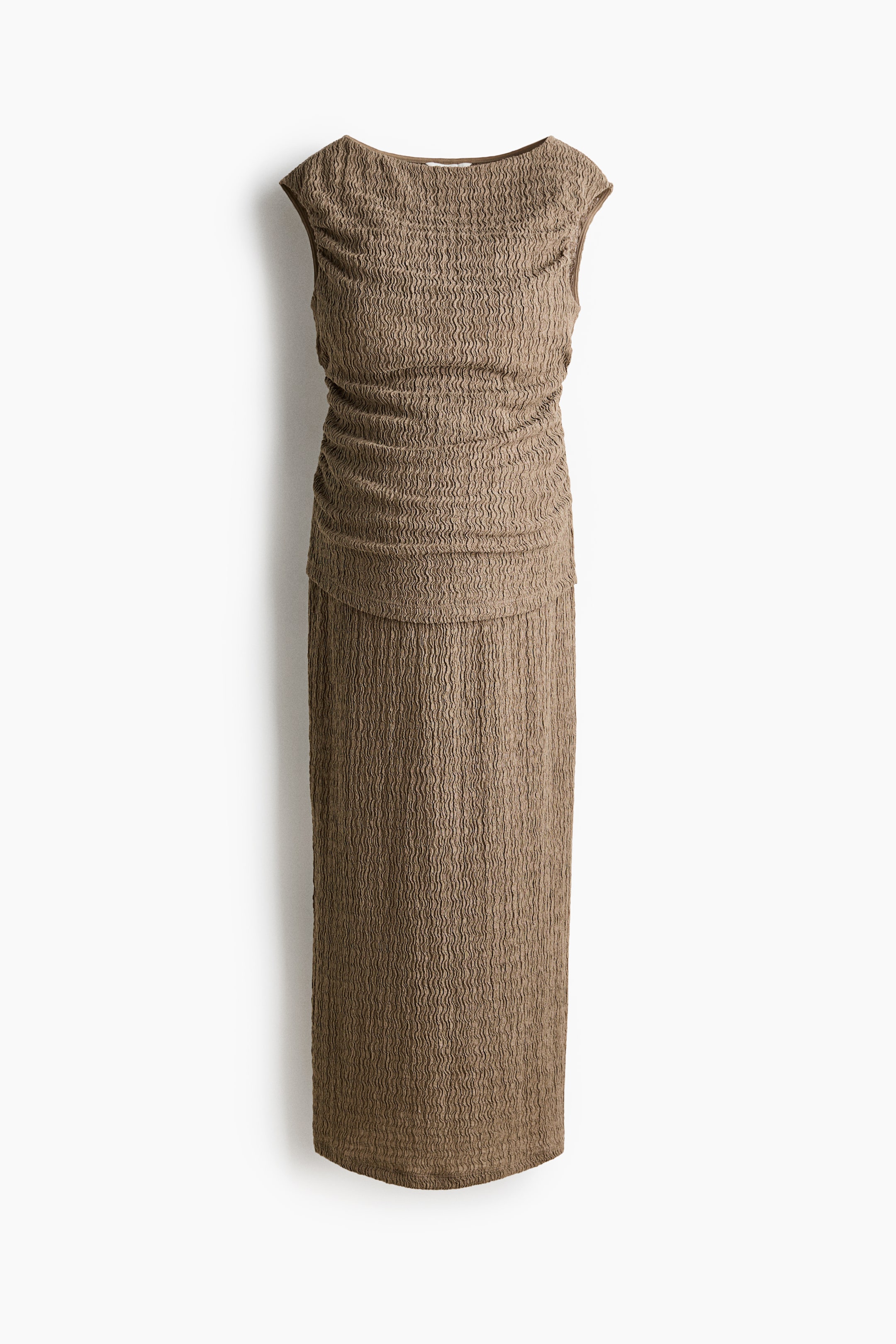 View larger image: A brown dress is showcased front-facing, featuring an all-over crinkled texture. It displays a sleeveless design with a boat neckline and a ruched bodice that gathers at the waist, flowing into a straight, full-length skirt.