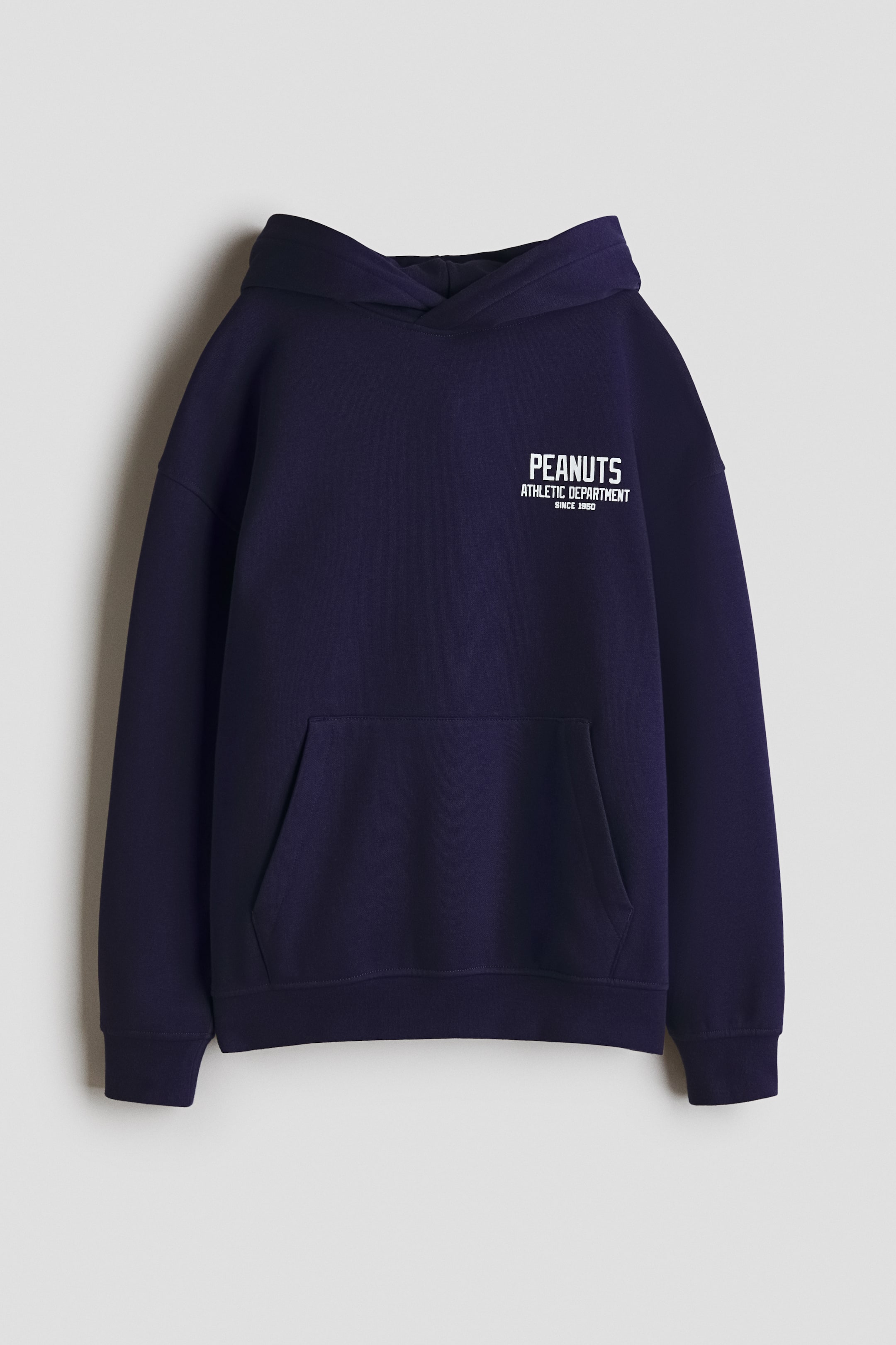 View larger image: A dark blue hoodie is facing forward, displaying a white "PEANUTS ATHLETIC DEPARTMENT SINCE 1950" graphic on the left chest, a large kangaroo pocket, and ribbed cuffs and hem.