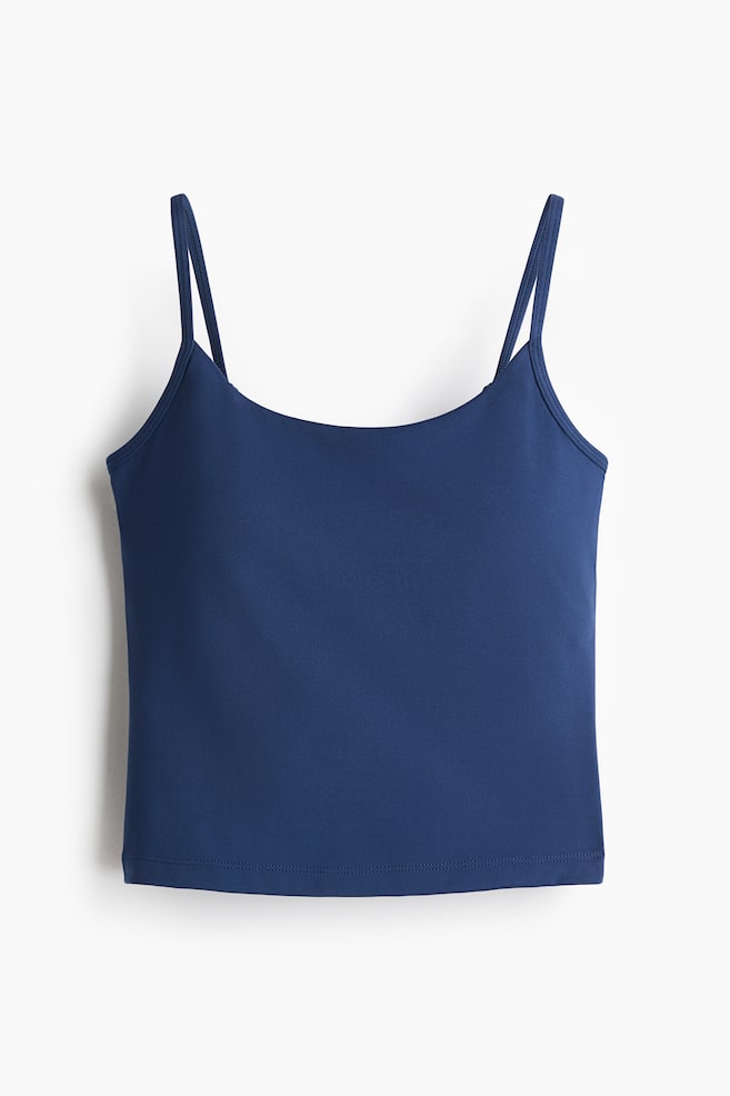 A dark blue camisole top is presenting FRONT, featuring thin spaghetti straps and a scoop neckline. The smooth fabric is ending in a straight, double-stitched hem. - 1