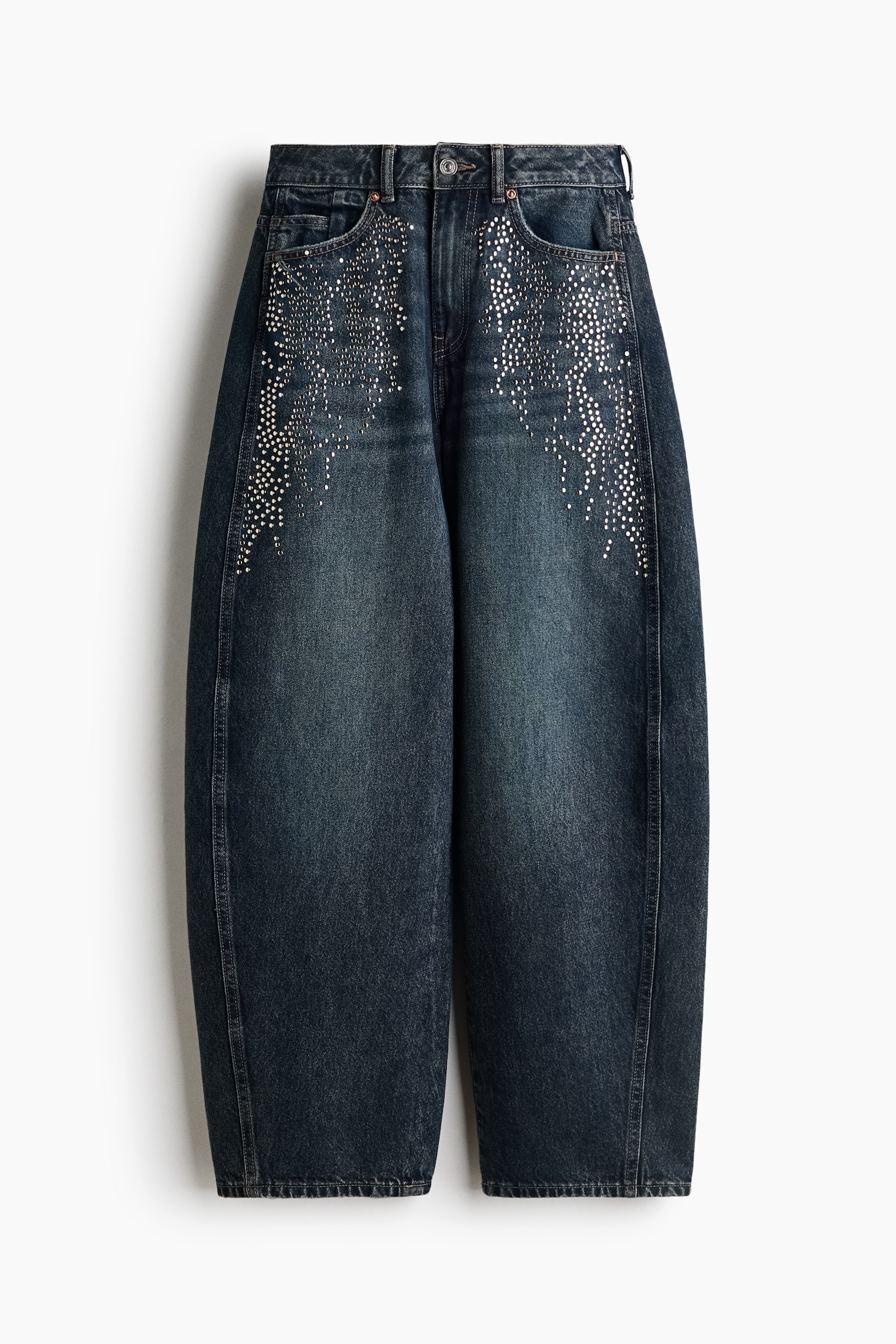 These high-waisted, dark wash denim jeans are shown from a front angle, featuring curved, voluminous legs that taper toward the hems. They are embellished with cascading silver rhinestones extending from the front pockets down the upper thighs, highlighting a classic five-pocket design with a button closure. - 1