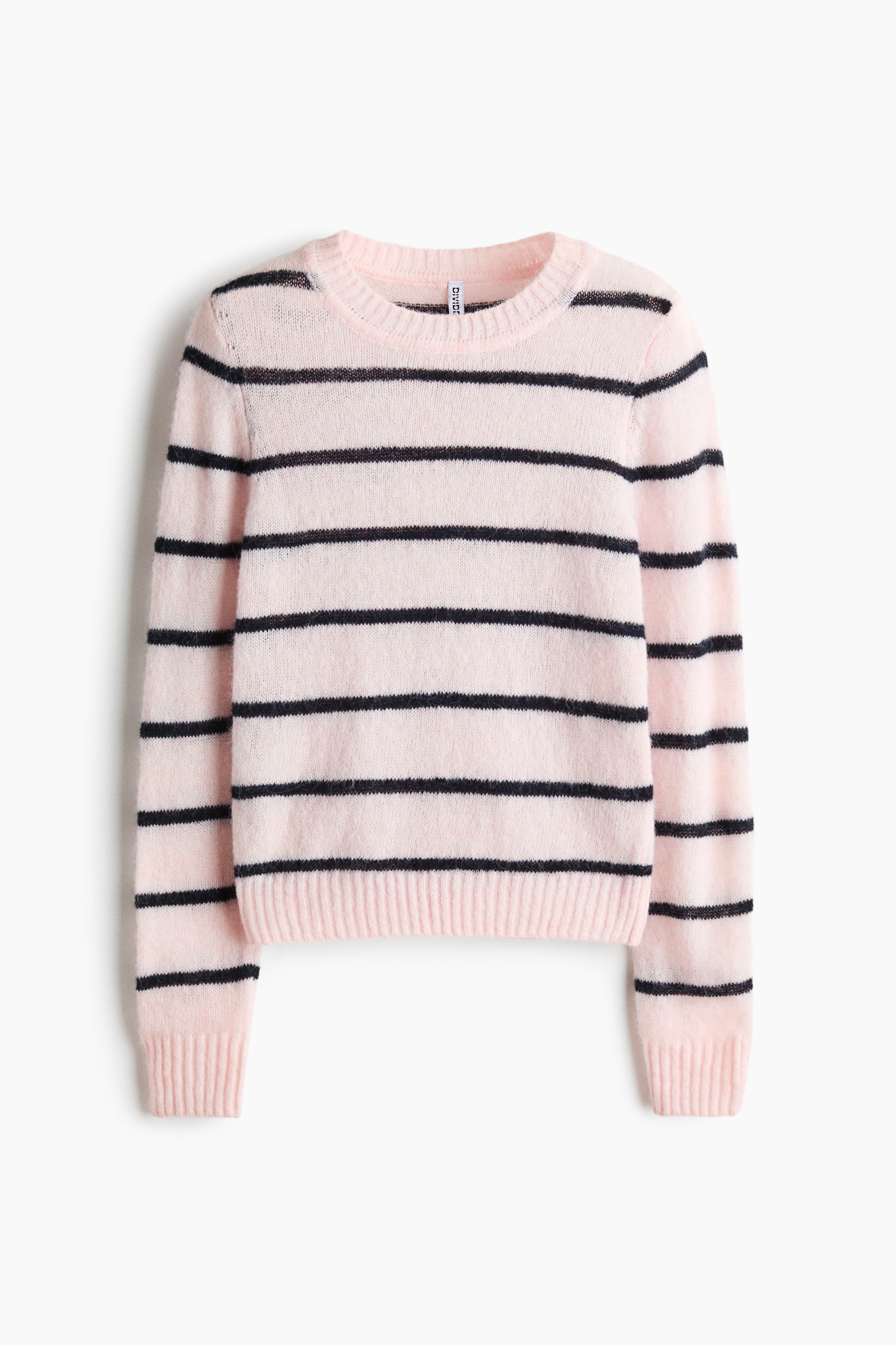A fitted, light pink sweater with horizontal black stripes is shown in a front view, styled over a grey and black striped long-sleeve top. The sweater features a ribbed crew neck, ribbed cuffs, and a ribbed hem, and is paired with black denim jeans.