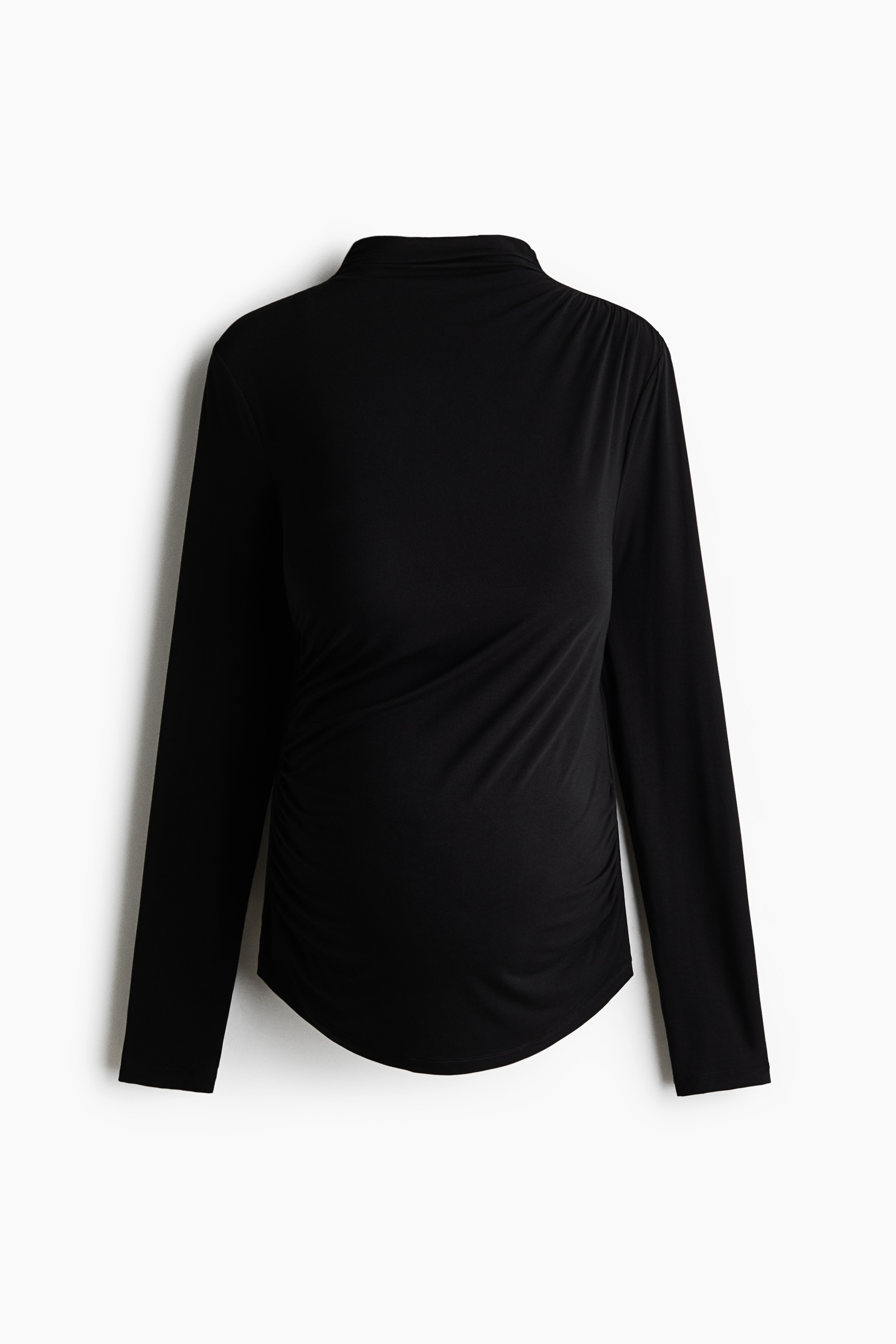 A fitted, high-neck black top with long sleeves and gathered side seams is being worn by the model, who is posing with one arm crossed and one hand resting near her chin.