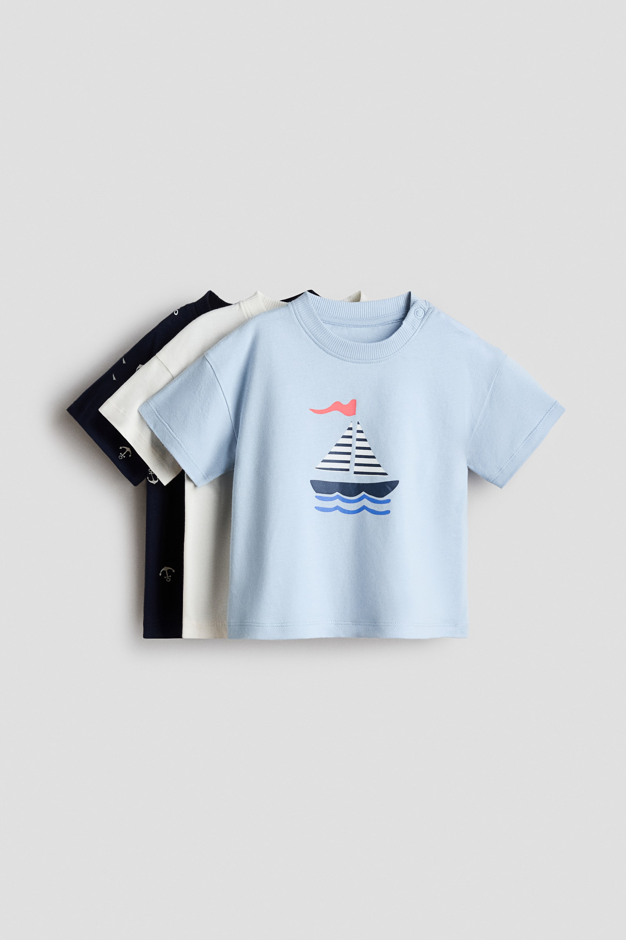 View larger image: This t-shirt is featuring a sailboat graphic and a ribbed crew neck with two snap buttons on the shoulder.