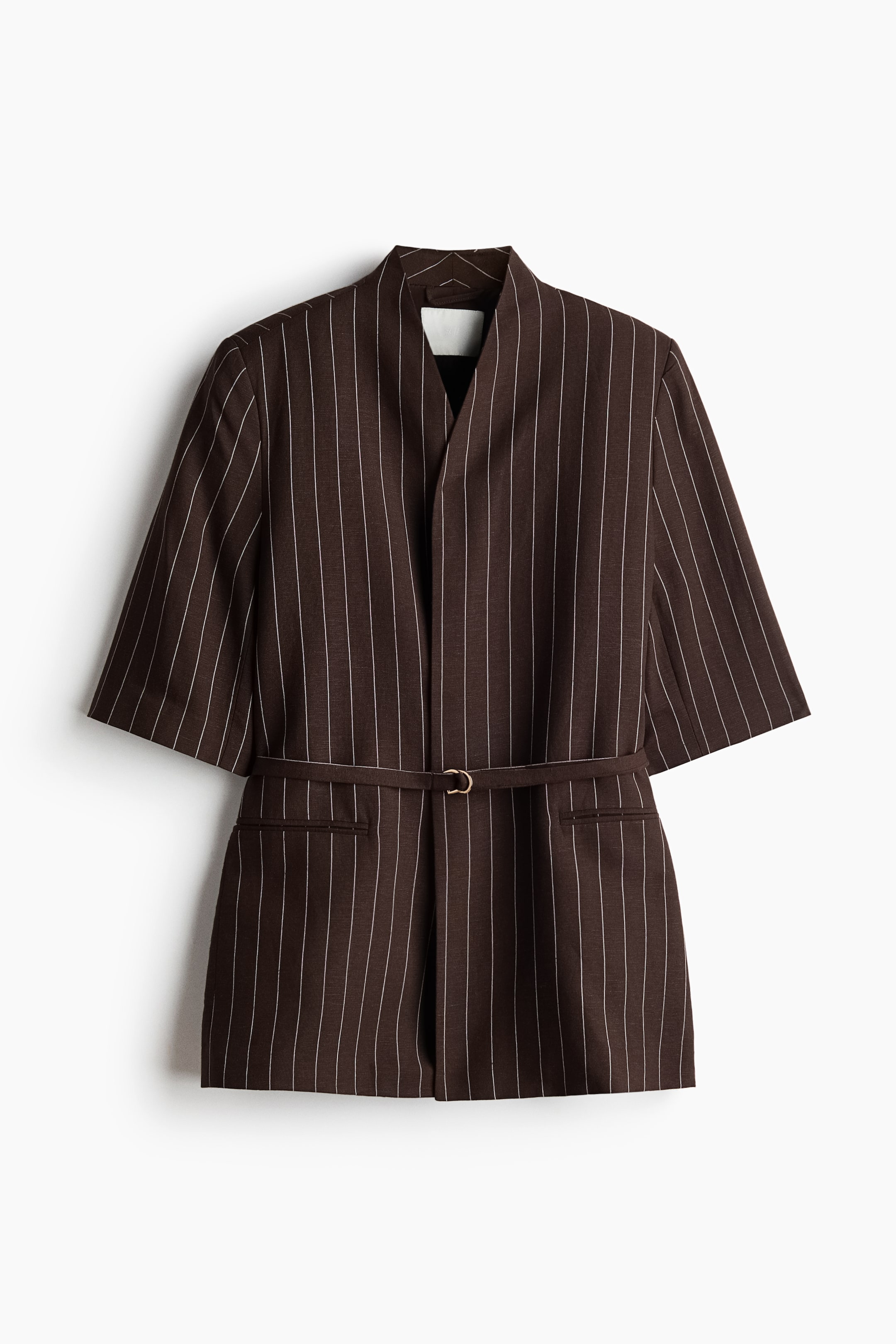View larger image: A brown pinstriped blazer showcases an open front with a stand-up collar and three-quarter length sleeves. A slim belt featuring a gold-toned circular buckle cinches the waist, while two welt pockets are visible below the belt.