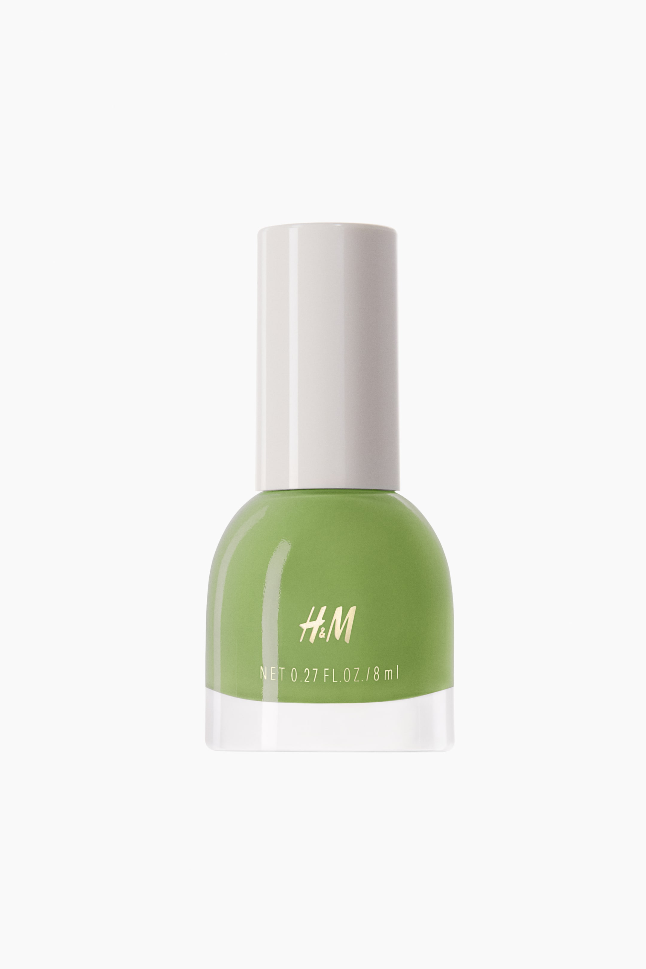 View larger image: The nail polish showcases a front-facing bottle with a dome-shaped body in a soft lime green hue, topped with a white cylindrical cap and a clear glass base. It prominently features the gold "H&M" logo and the text "NET 0.27 FL. OZ. / 8 ml" on its front.