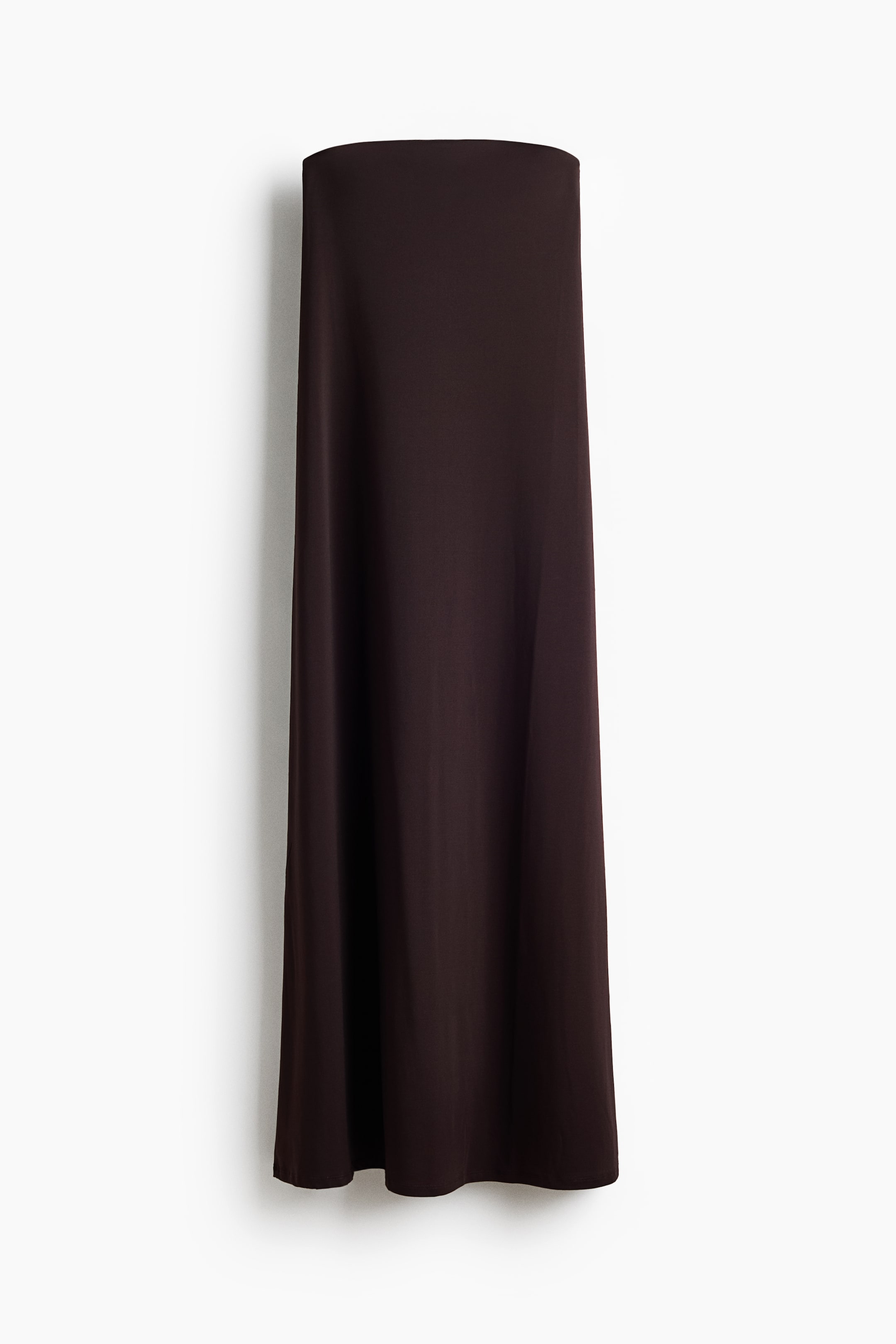 View larger image: The dark brown tube maxi skirt is displayed front-facing, showcasing its flat top edge and smooth fabric that flows down to a straight hem.
