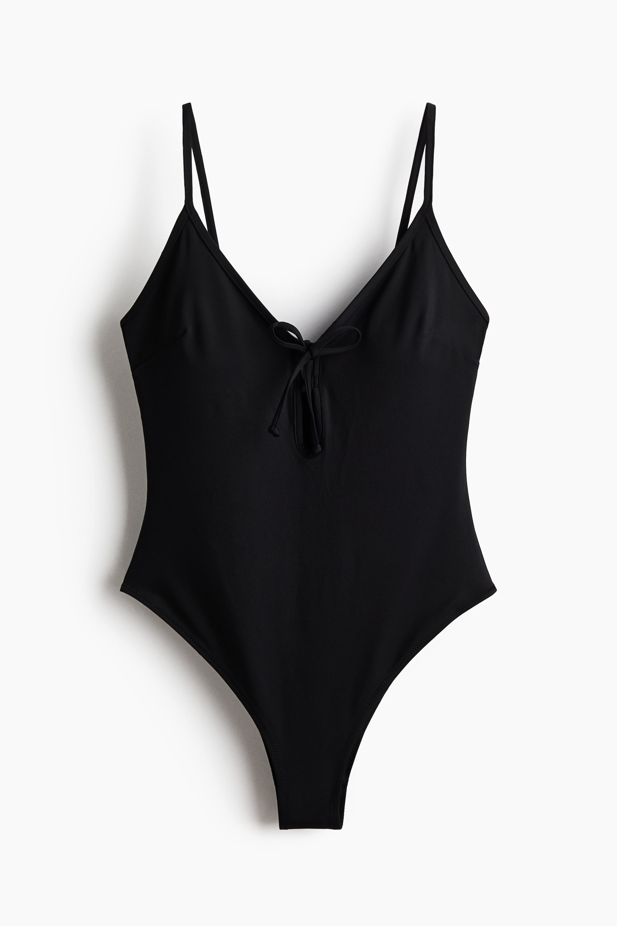 View larger image: A black swimsuit is showcased from the front, featuring a V-neck, slender shoulder straps, a keyhole opening with narrow ties at the top of the front, and high-cut legs.