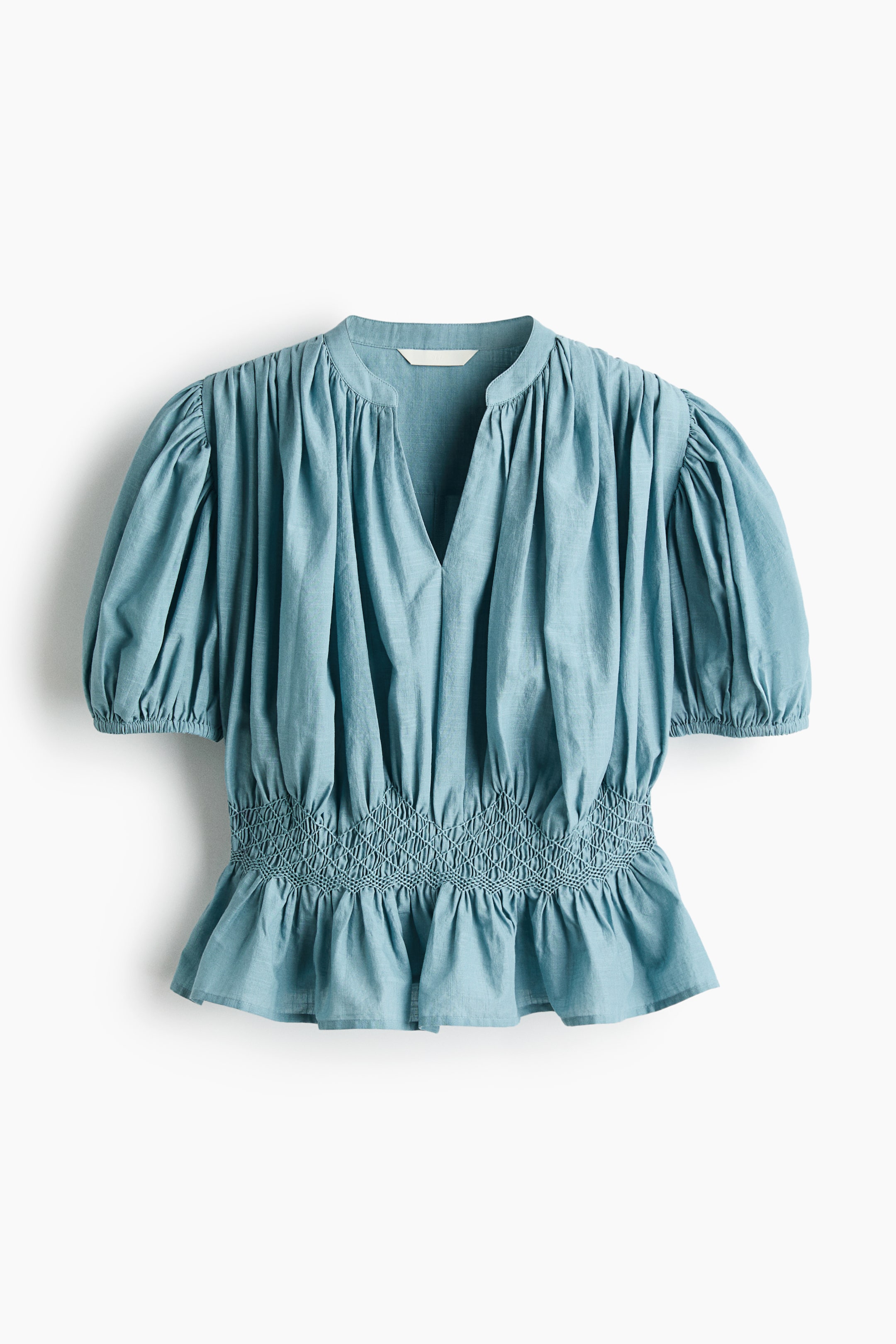 View larger image: This description remains largely unchanged as the original language is English, and the target locale is also English-speaking (India). However, subtle adjustments can be made to ensure cultural resonance:
"A blue top is showcased from the front, featuring a V-neck, short puffed sleeves, and a smocked waist with a diamond pattern, culminating in a peplum hem."