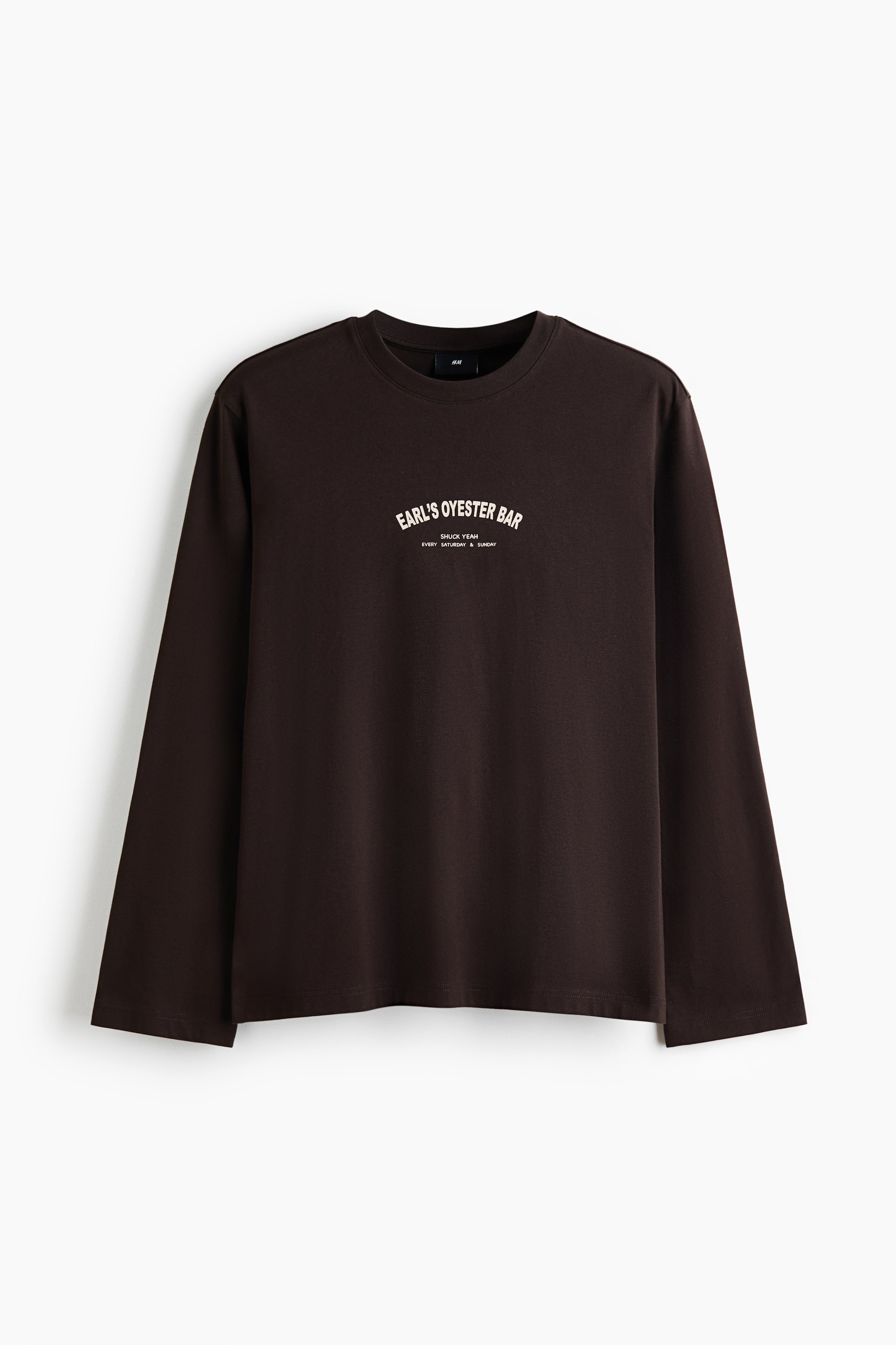 View larger image: A dark brown long-sleeve t-shirt featuring a crew neck and long sleeves, presented facing forward. It displays a white text graphic on the chest, reading "EARL'S OYSTER BAR" arched above "SHUCK YEAH!" and "EVERY SATURDAY & SUNDAY."