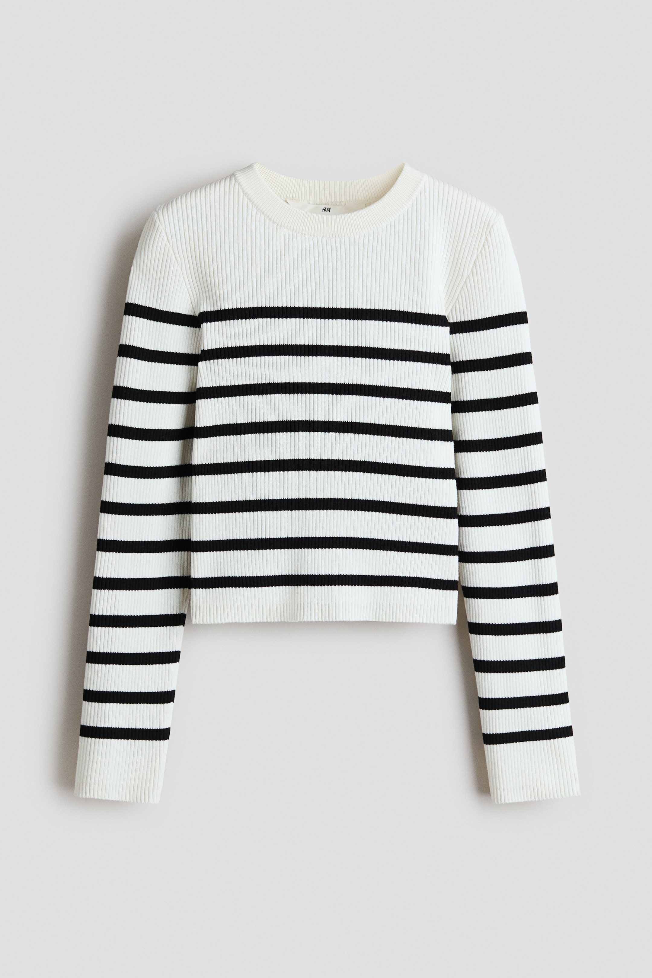 View larger image: This jumper is depicted from the front, showcasing a white ribbed knit with black horizontal stripes. It is crafted with a crew neck, long sleeves, ribbed cuffs, and a straight bottom hem.