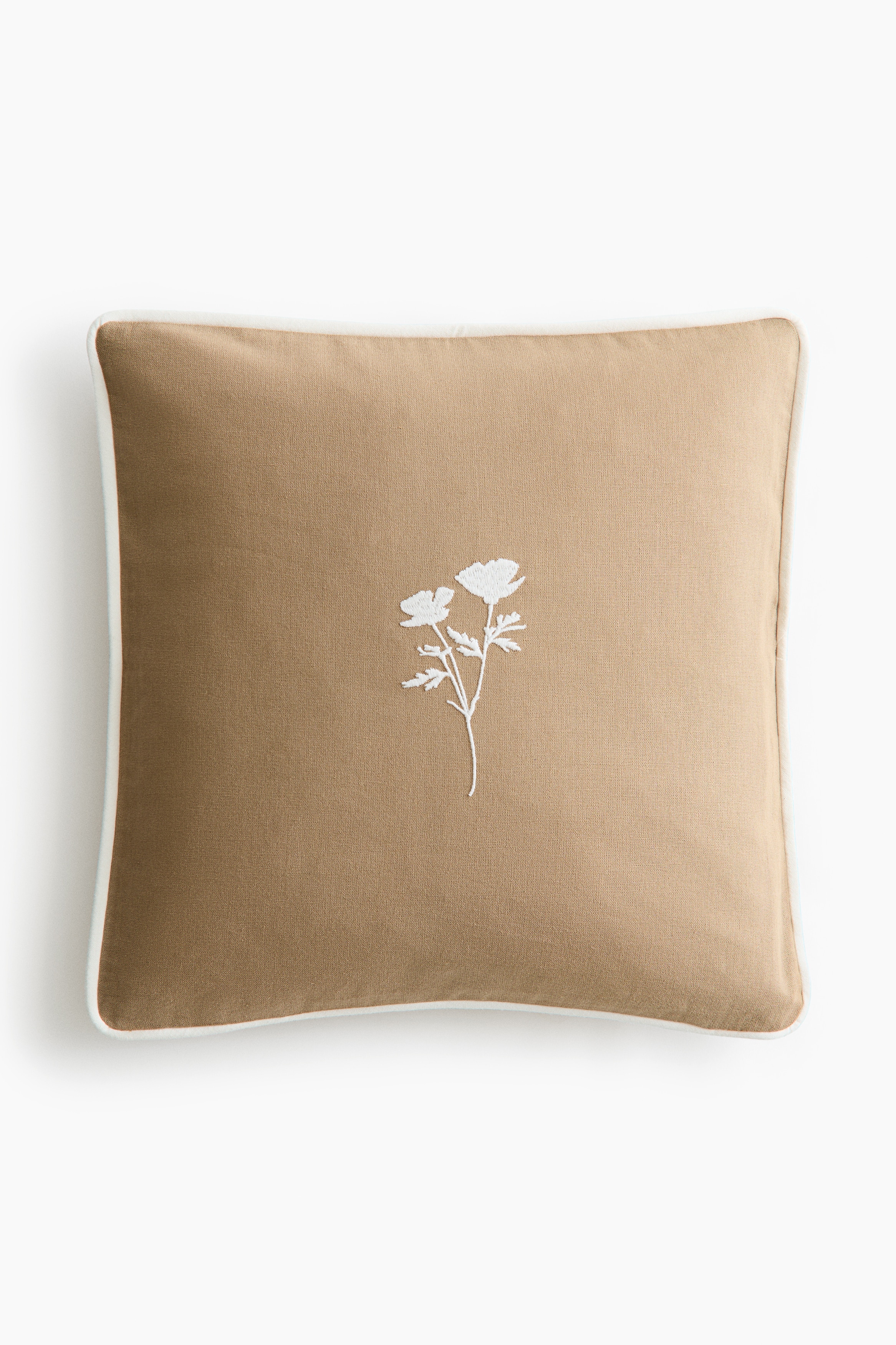 Housse de coussin en coton avec motif brodéModèle