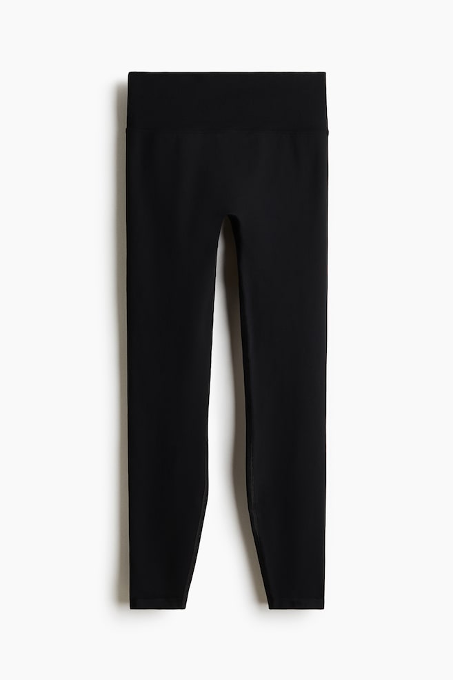 The front of the leggings is displaying a largely seamless design. - 1