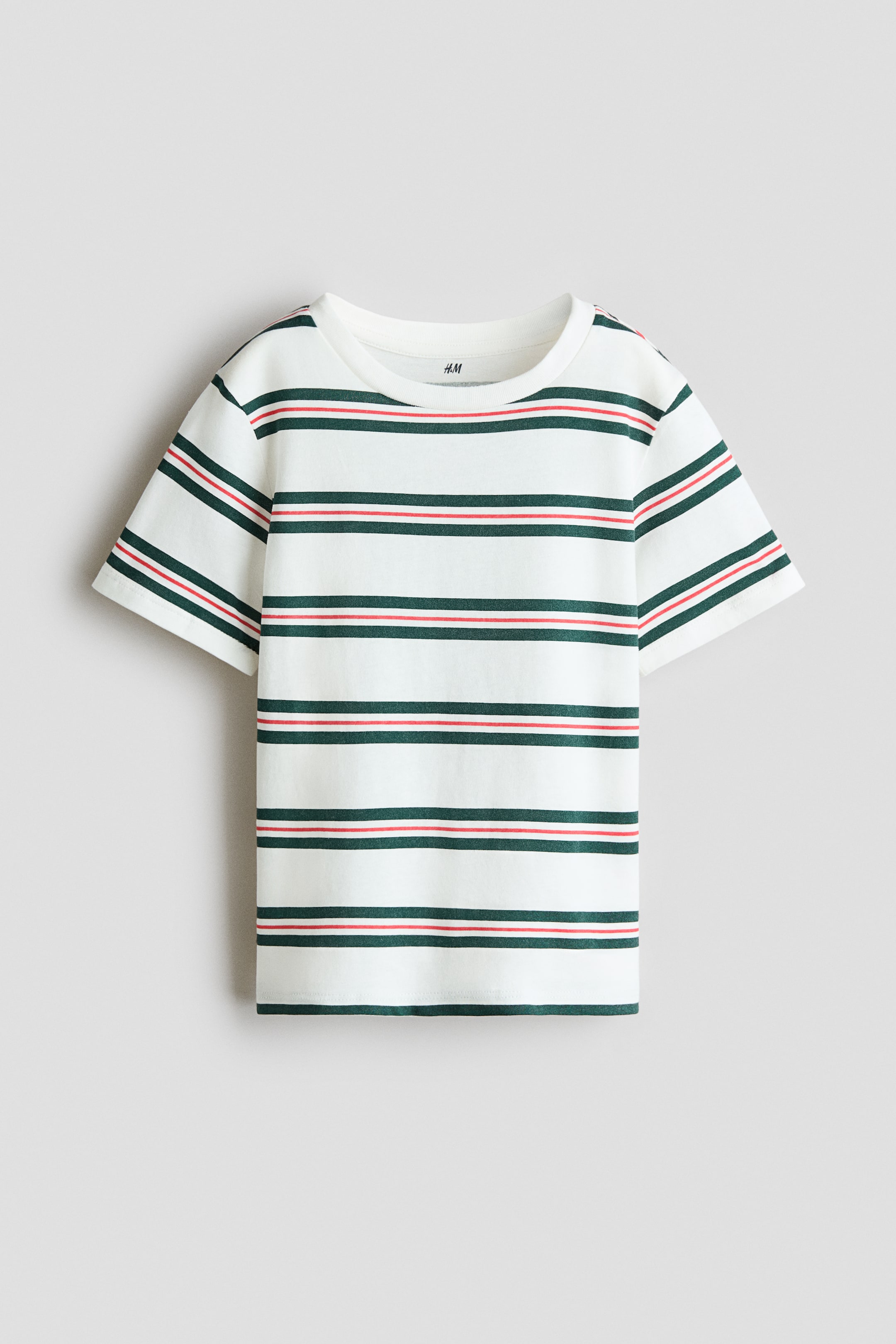 View larger image: A T-shirt is shown from the front, made of white cotton jersey and featuring horizontal dark green and red stripes. It is designed with a round, ribbed neckline and gently dropped shoulders.