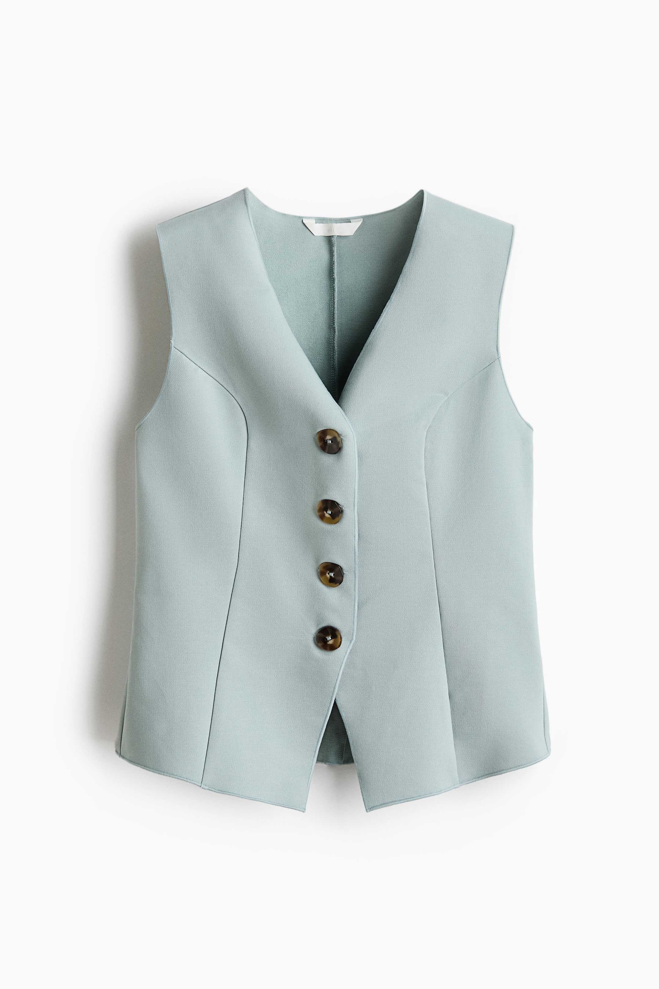 View larger image: A light blue sleeveless vest showcases its front, highlighting a deep V-neckline. Four brown, tortoiseshell-patterned buttons secure the front closure. Vertical seams define the vest's tailored silhouette, while the front hem features a subtle split.