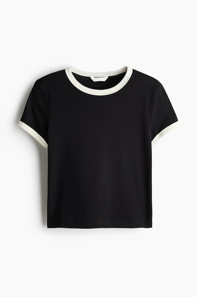 A black fitted T-shirt is shown from the front, featuring a round neckline and short-sleeve cuffs detailed with a contrasting off-white trim, along with a straight-cut hem. - 1