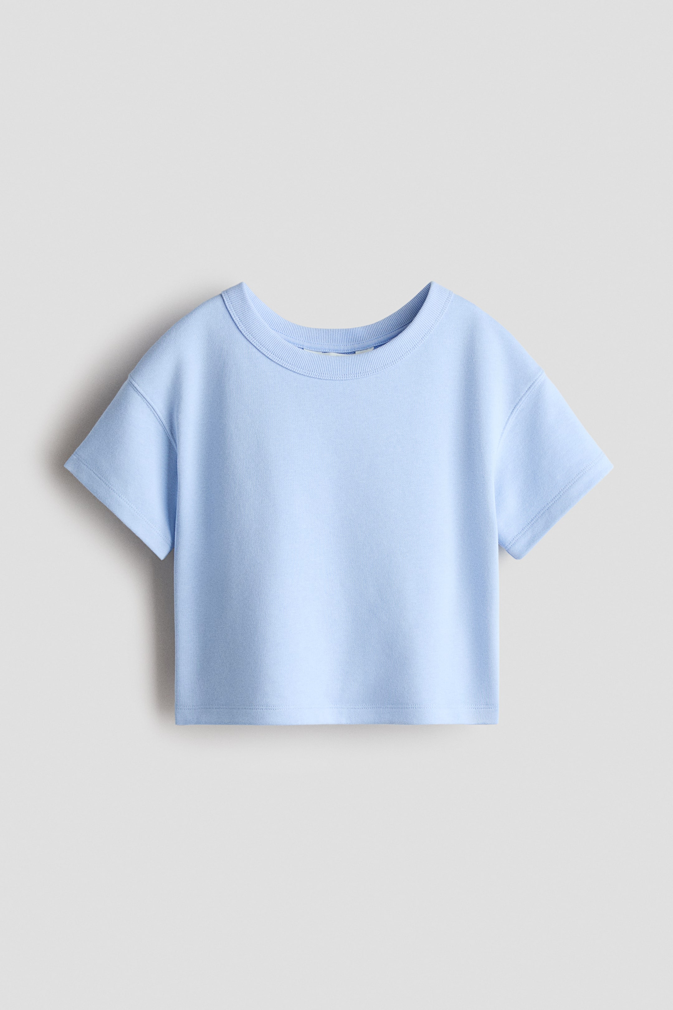 View larger image: A light blue t-shirt showcases its front view, highlighting a ribbed crew neck and short sleeves. It's crafted with a straight, cropped hem.