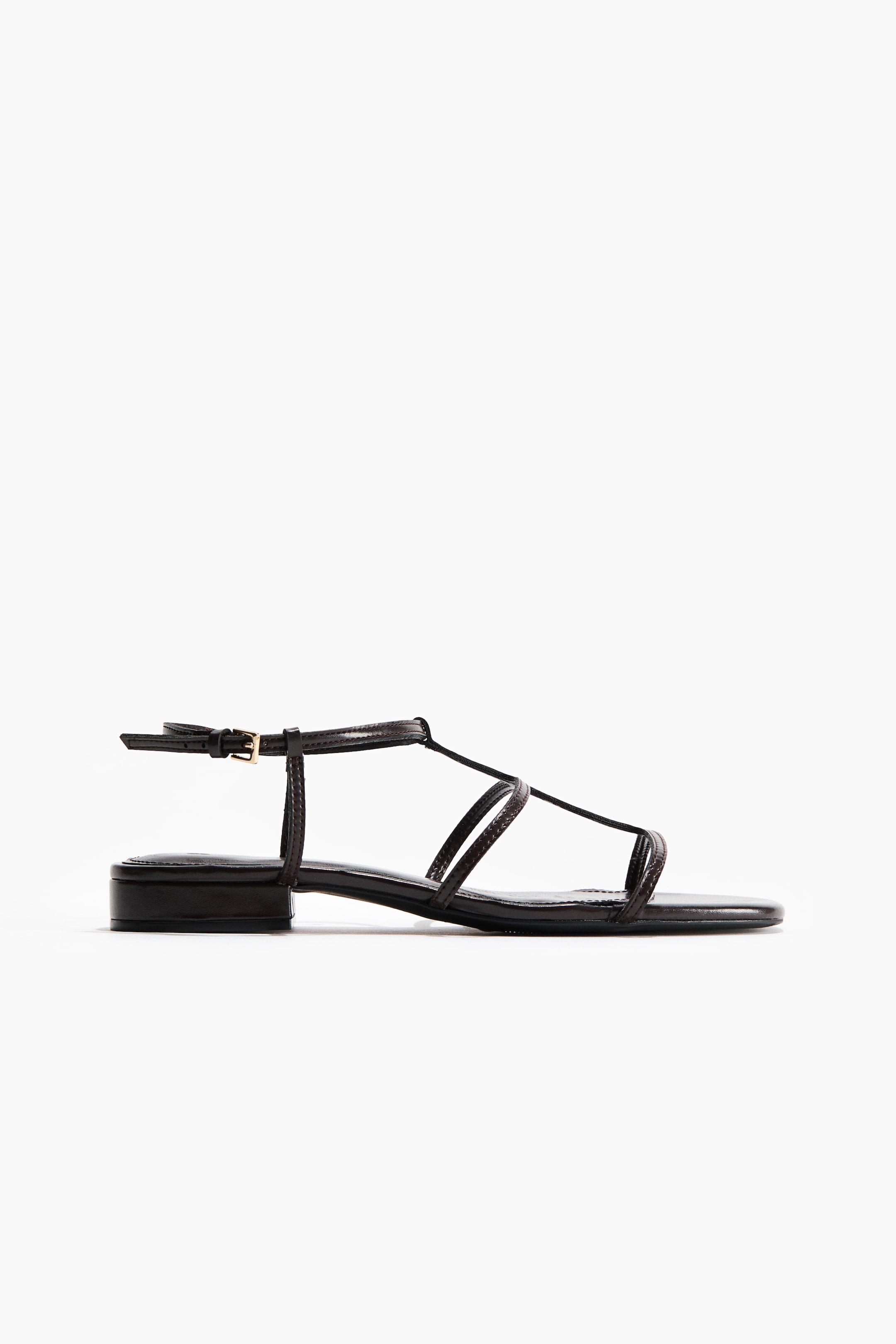 View larger image: The sandal is showcased from the front, highlighting square toes, slender foot straps, and a slim, adjustable ankle strap with a metal buckle.
