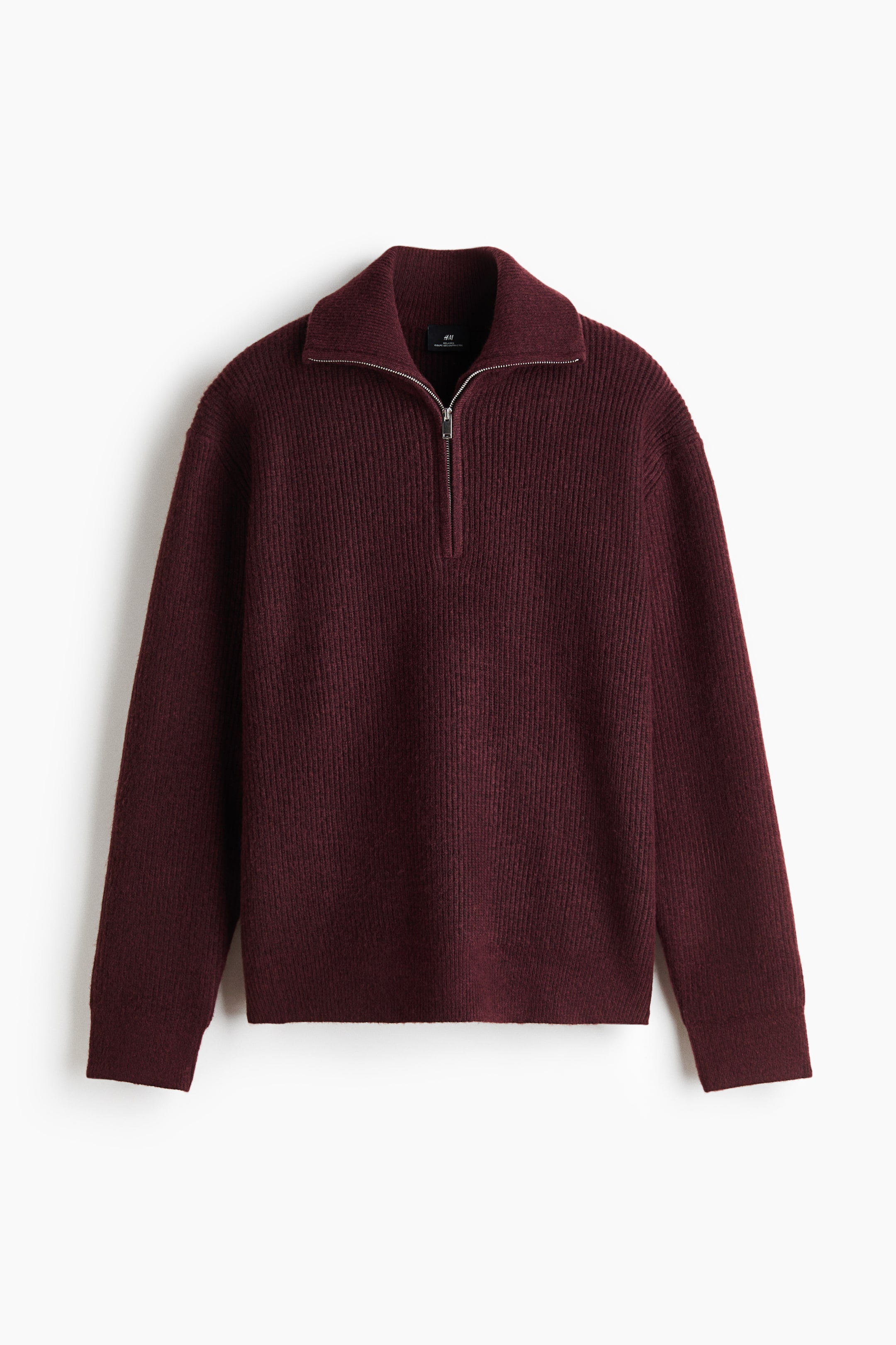 View larger image: A burgundy ribbed knit sweater is shown from the front, featuring a wide collar with a silver-tone half-zip closure. The long-sleeved garment displays a textured vertical ribbed pattern throughout and is finished with ribbed cuffs.