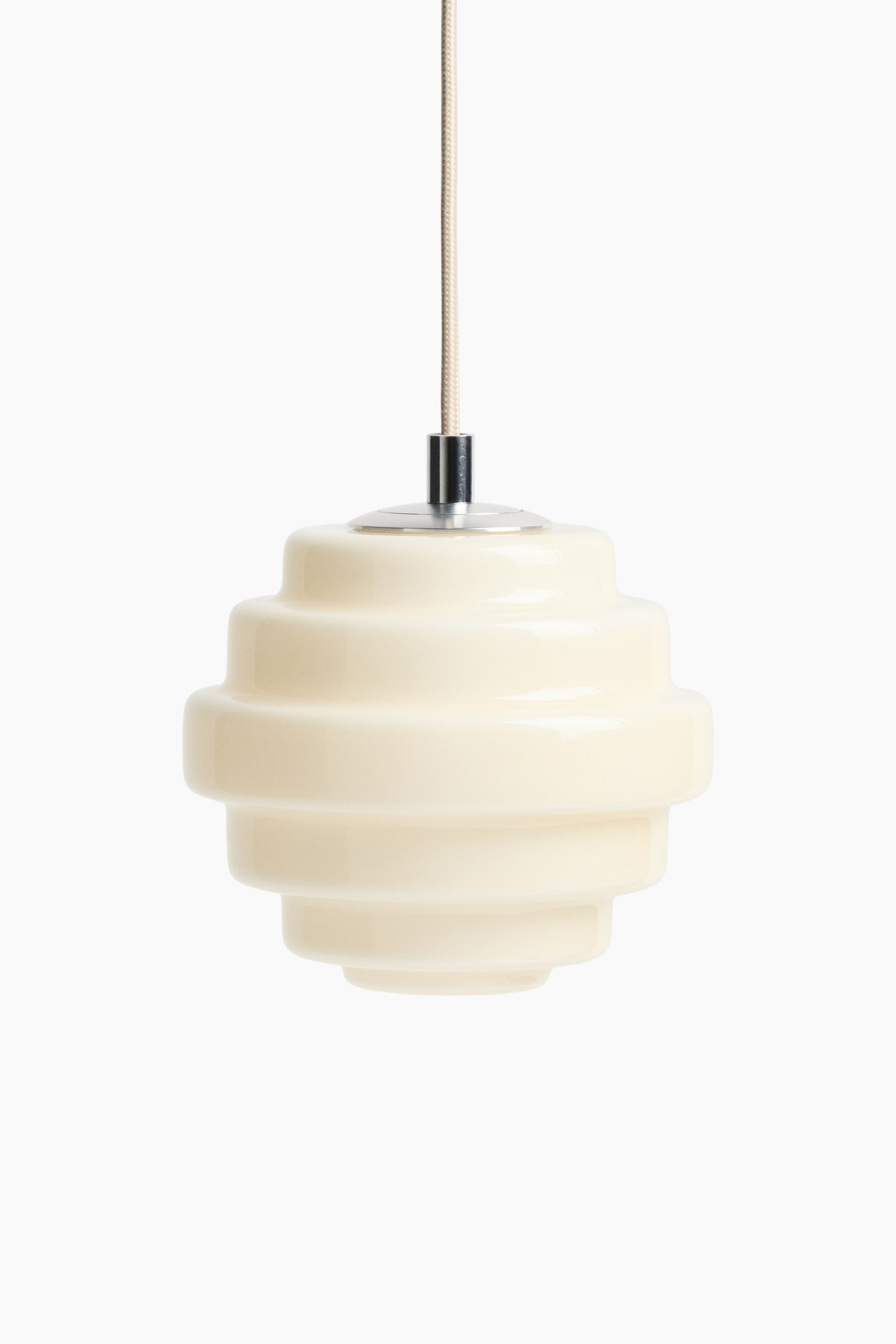 View larger image: A cream pendant light is hanging, showcasing a glossy, stacked, rounded design with multiple horizontal tiers. A silver-toned cap connects the light fixture to a braided, light-coloured cord at the top.