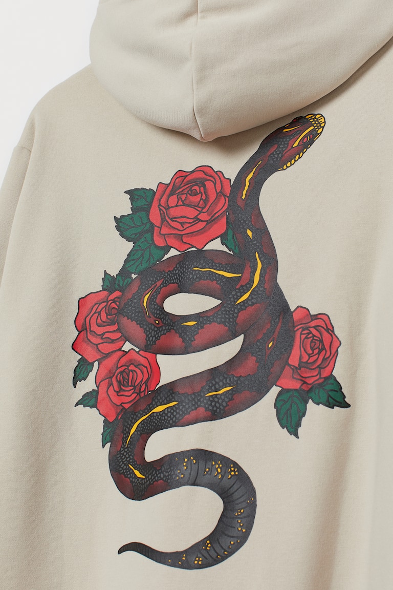 Hooded top with a motif