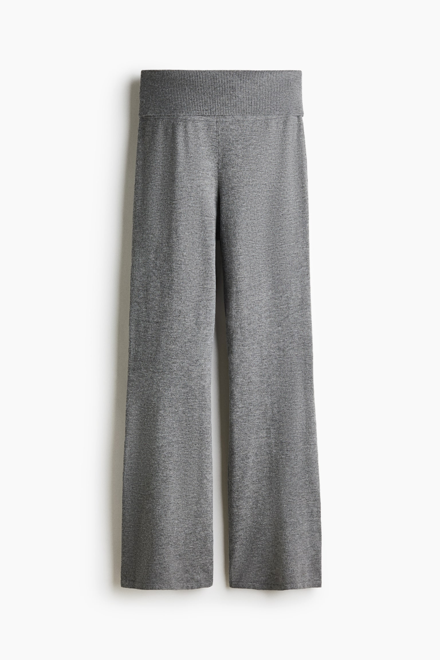 Gray knit pants are hanging in a front view, featuring a wide, ribbed foldover waistband and long, flared legs made from a soft, heathered knit fabric. - 1