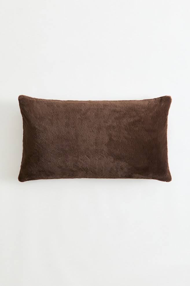 A brown rectangular pillow is presenting its front side, featuring a soft, plush texture. - 1