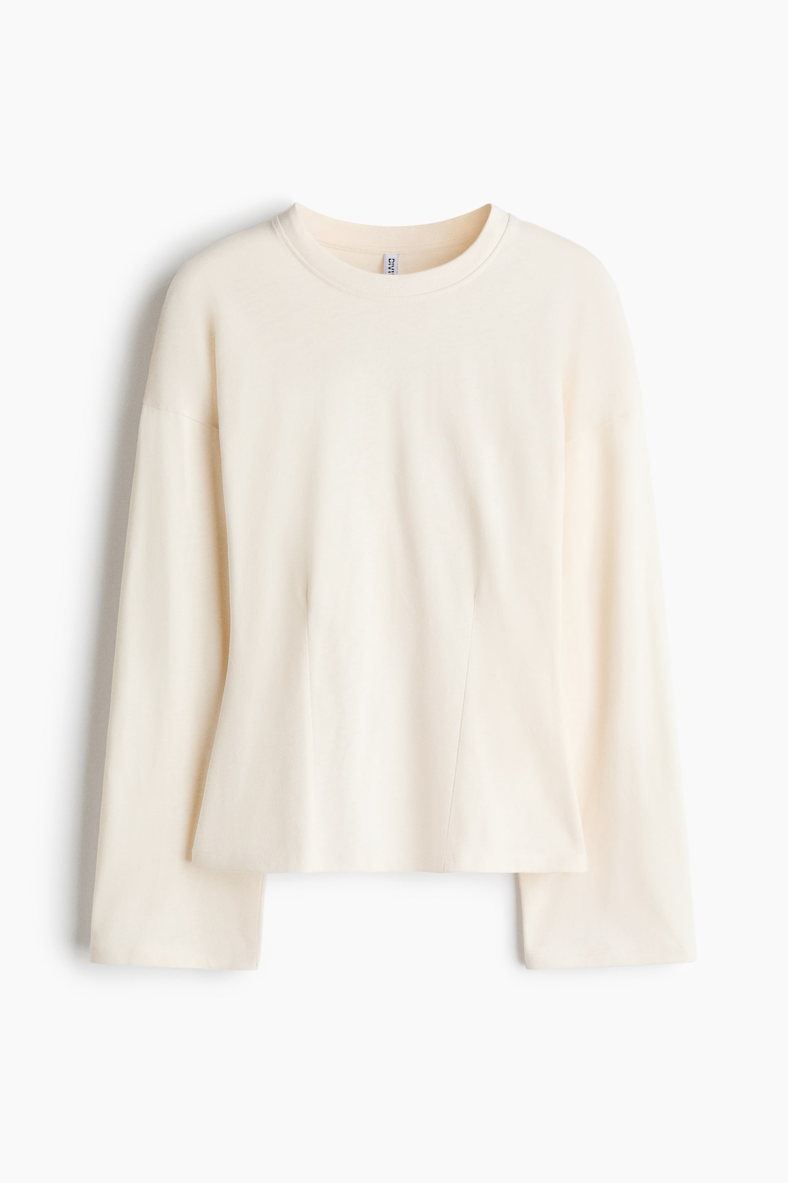 A cream long-sleeved top is shown facing forward, featuring a crew neck and wide, flared sleeves. Two vertical shaping seams curve from the mid-torso towards the cropped, split hem at the front. - 1