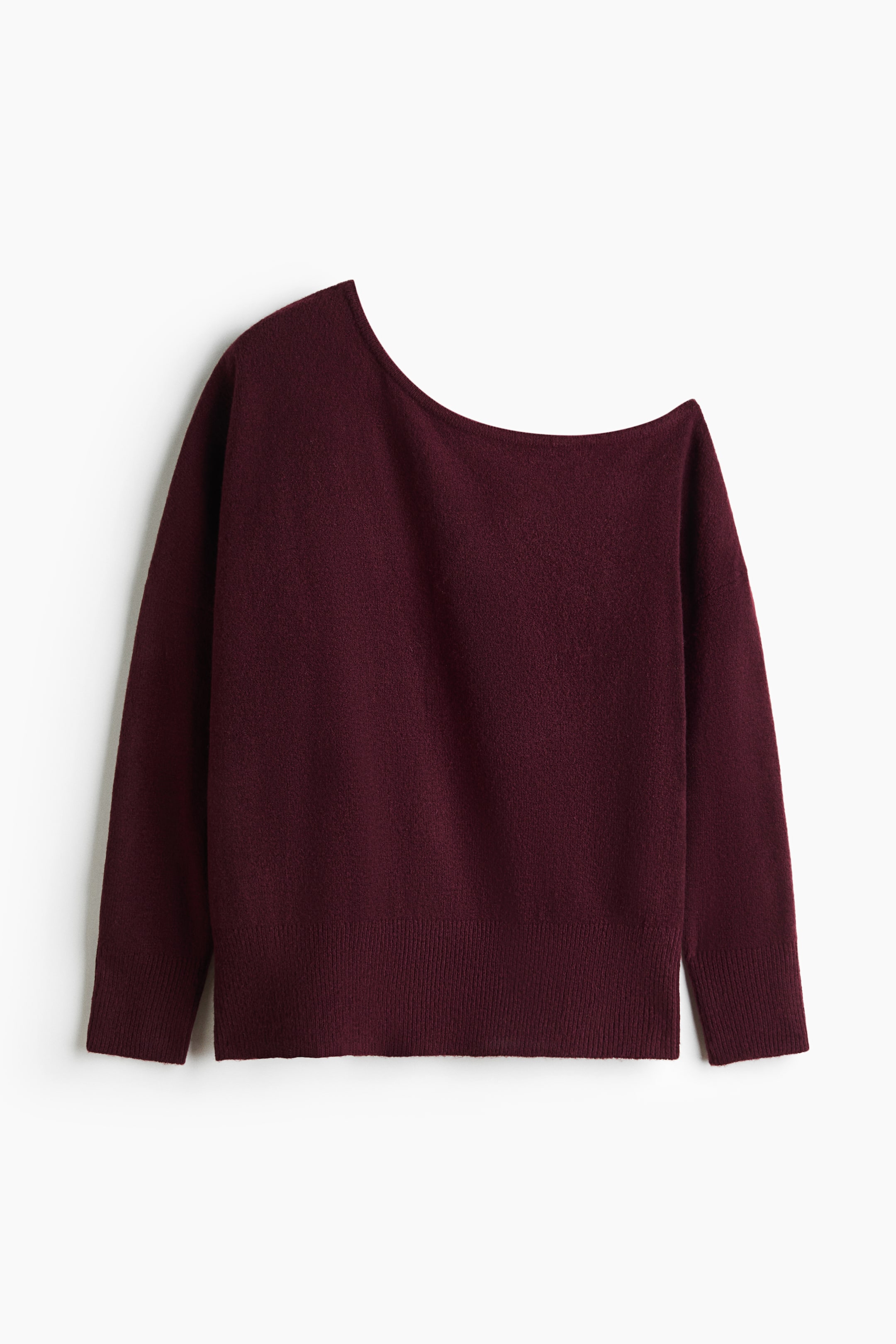 View larger image: A burgundy knit sweater features an asymmetrical, one-shoulder neckline and long sleeves. The garment has a soft texture with ribbed cuffs and a wide ribbed hem.