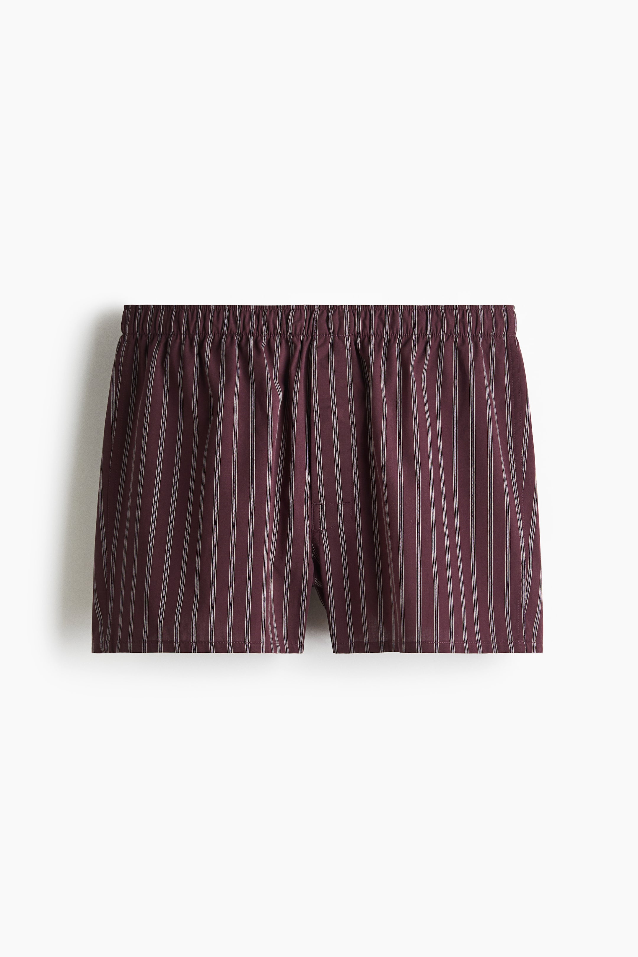 View larger image: Boxer shorts are presented in a soft, maroon weave, featuring thin vertical white stripes. An elasticated waist and long legs are visible.