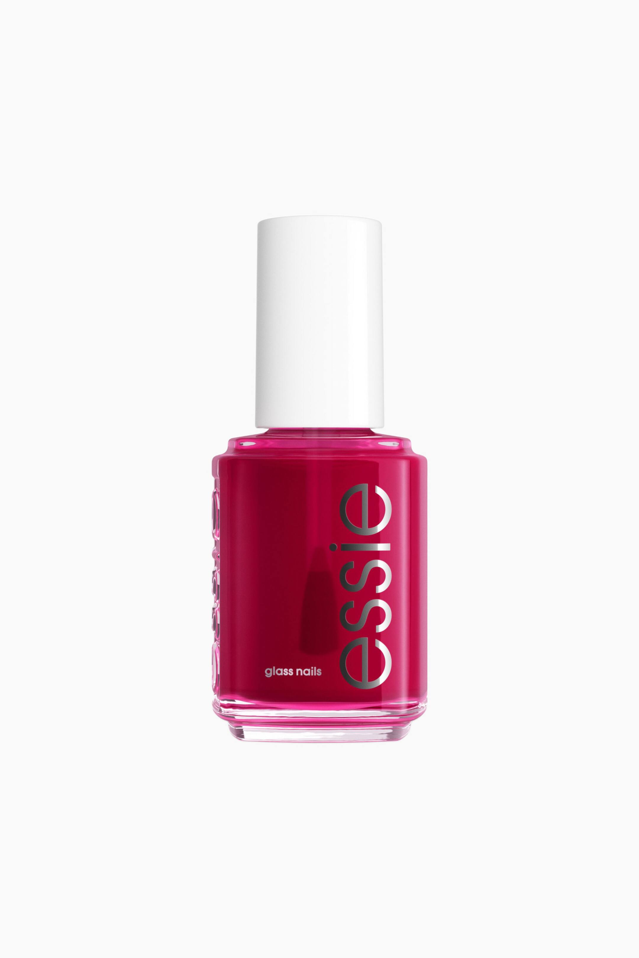 Se større billede: En flaske neglelak i fuchsia står opret og har en klar glasbeholder fyldt med fuchsia-neglelak samt et hvidt låg. 'essie'-logoet er synligt lodret i sølvfarvet skrift på forsiden, med teksten 'glass nails' trykt nedenunder.