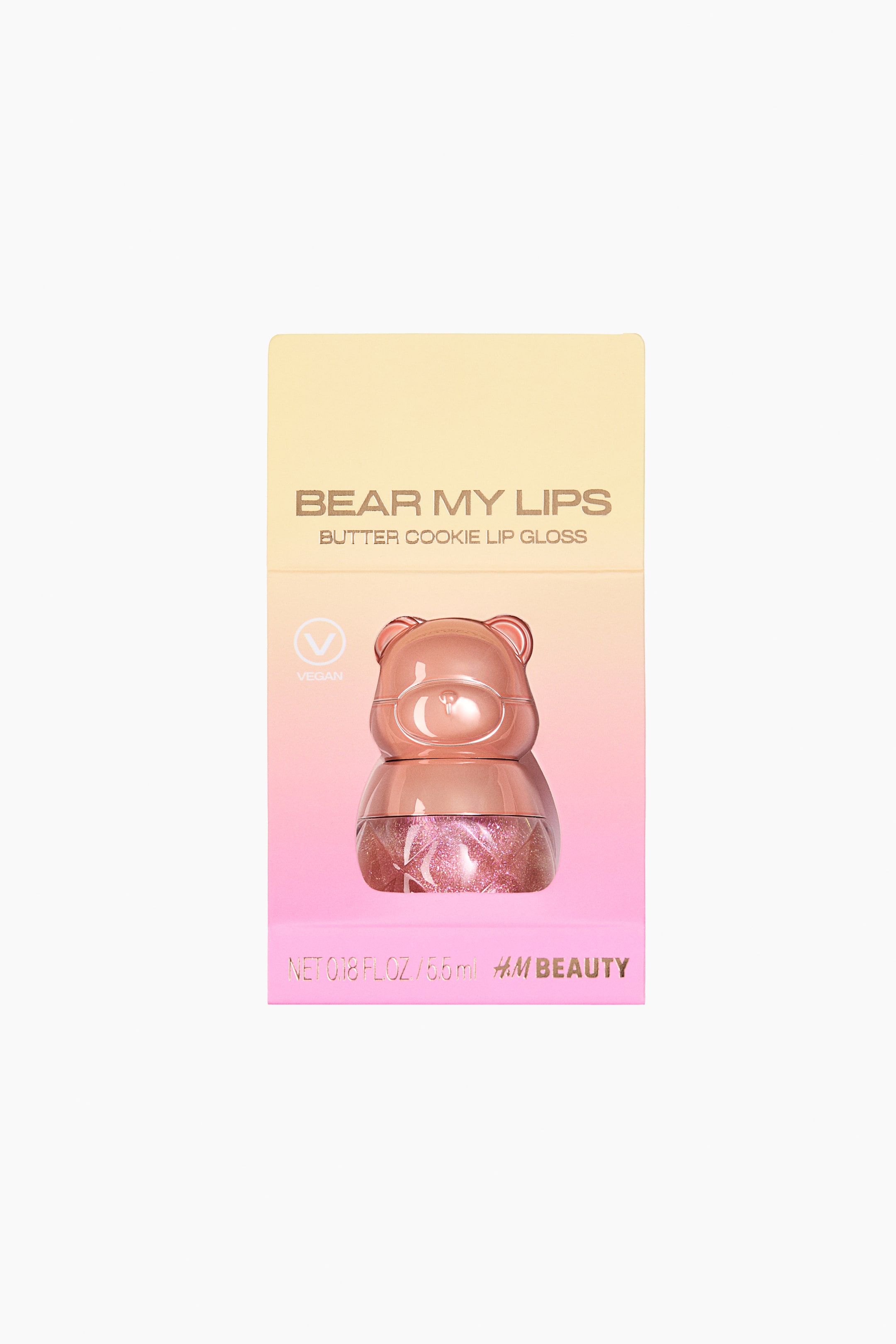 View larger image: A bear-shaped lip gloss container features a solid, rosy-brown bear head as its top, with a clear bottom part holding shimmering pink lip gloss. This container is showcased frontally within a rectangular package displaying a light yellow to pink gradient. The packaging includes the text "BEAR MY LIPS BUTTER COOKIE LIP GLOSS," a "VEGAN" symbol, "NET 0.18 FL.OZ / 5.5ml," and "H&M BEAUTY."
