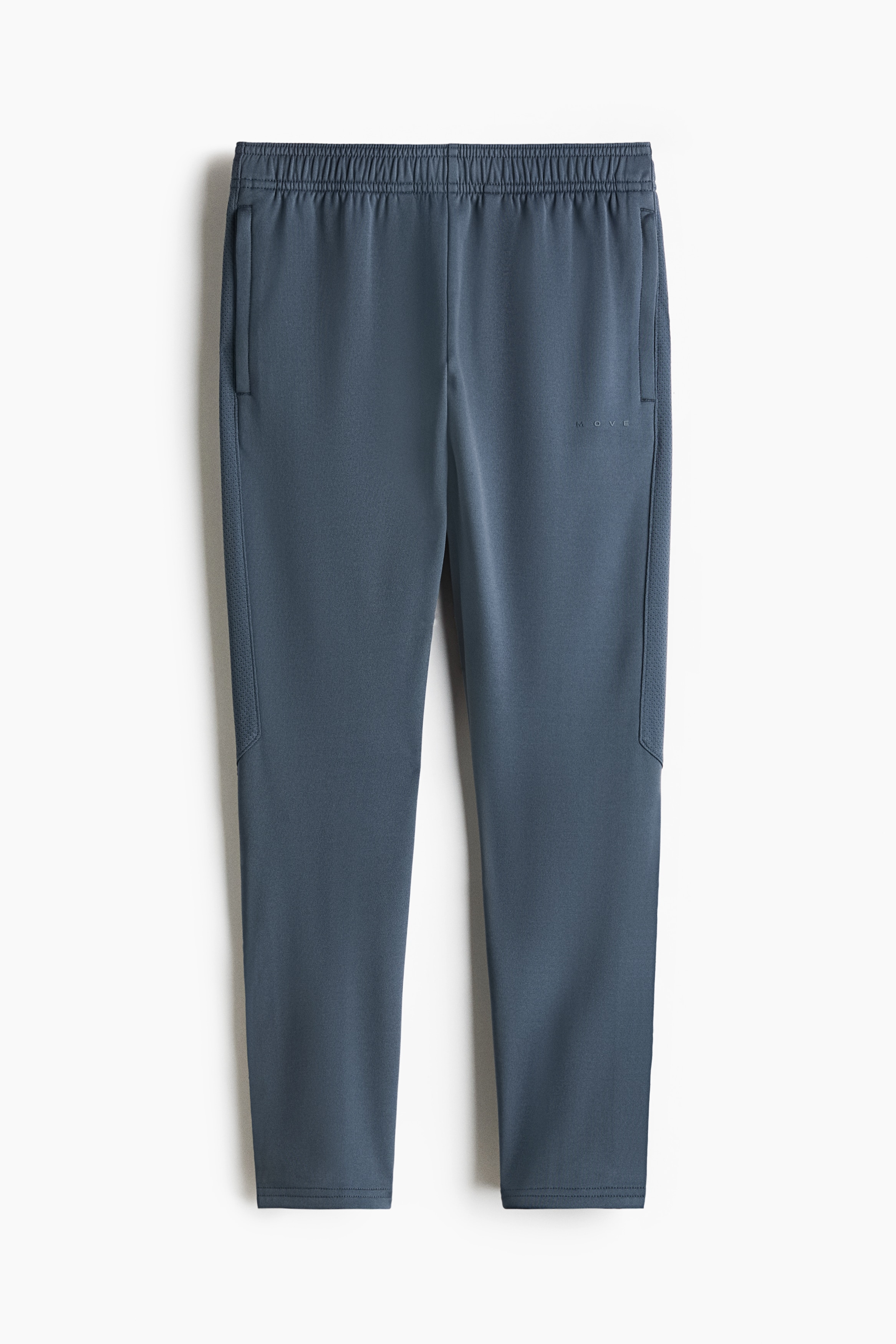 A two-piece athletic set is shown from the front, featuring a light green and dark grey colour-blocked quarter-zip top paired with dark grey joggers. The long-sleeve top is displaying a high collar and raglan sleeves with thumbhole cuffs, while the matching joggers are showing a tapered fit.