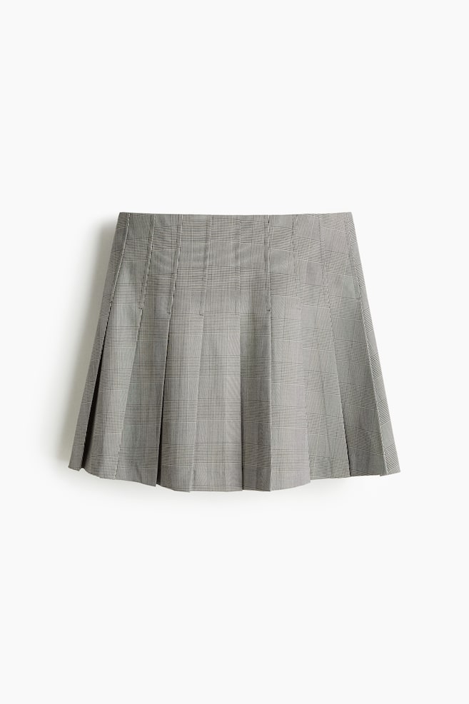 A front view of a grey Glen check pleated skirt is showing its crisp, vertical pleats. - 1
