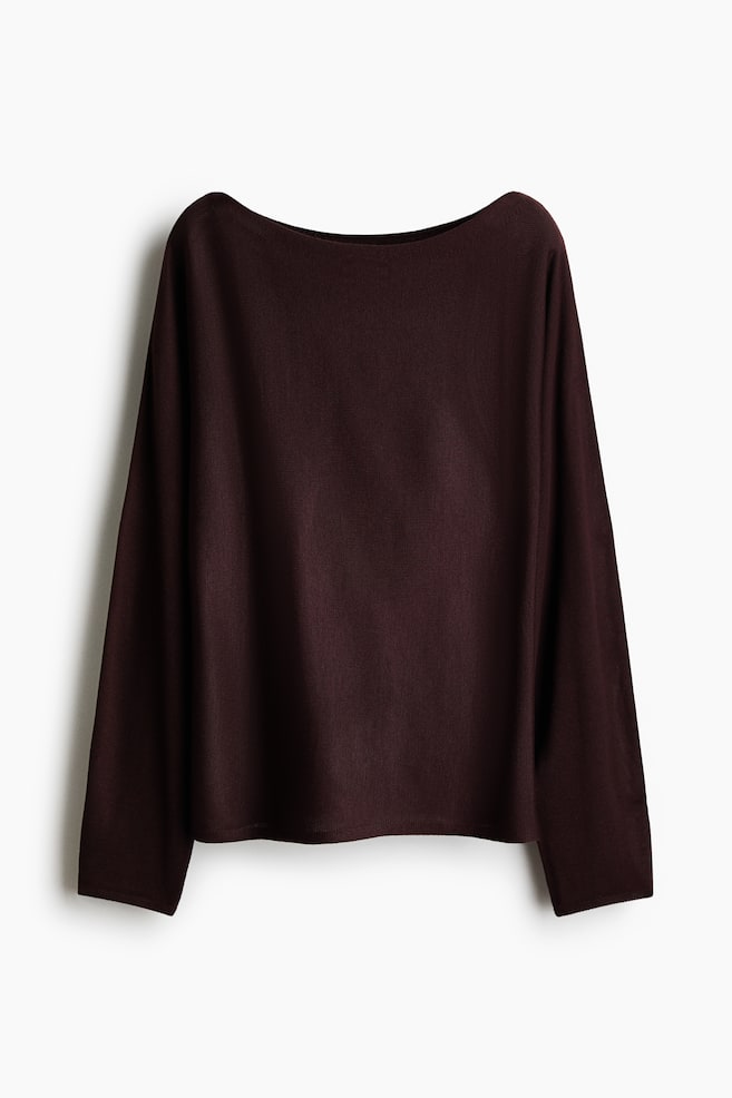 A dark brown-red knit top is displaying its back, featuring a wide boat neckline, long loose sleeves, and a smooth, fine knit texture with a relaxed fit. - 1