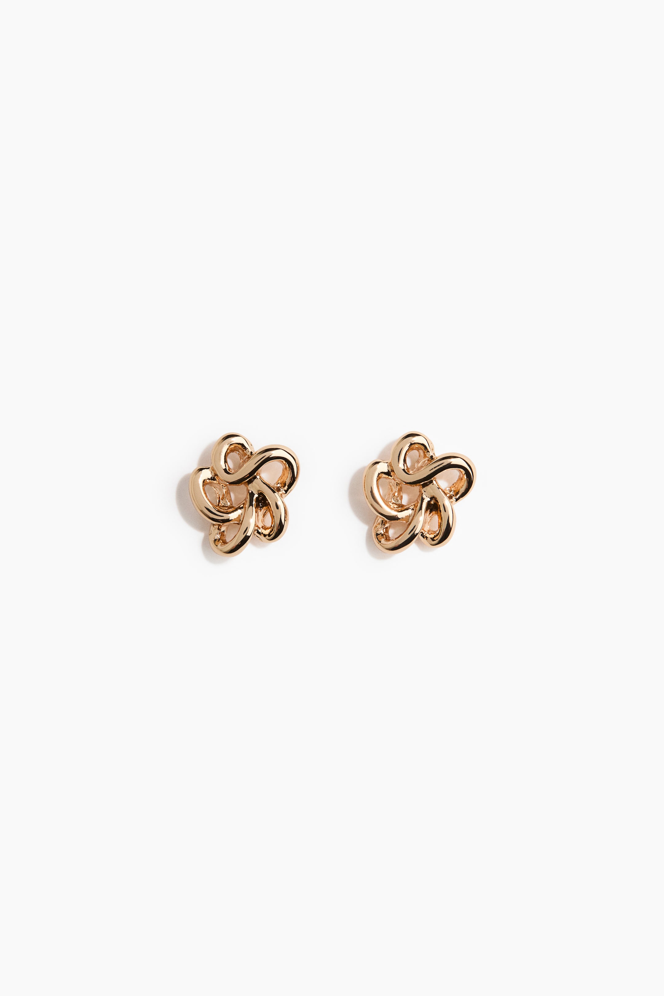 View larger image: A pair of gold-tone stud earrings features a stylized floral design, crafted with intricately intertwined loops that create a three-dimensional, knot-like appearance.