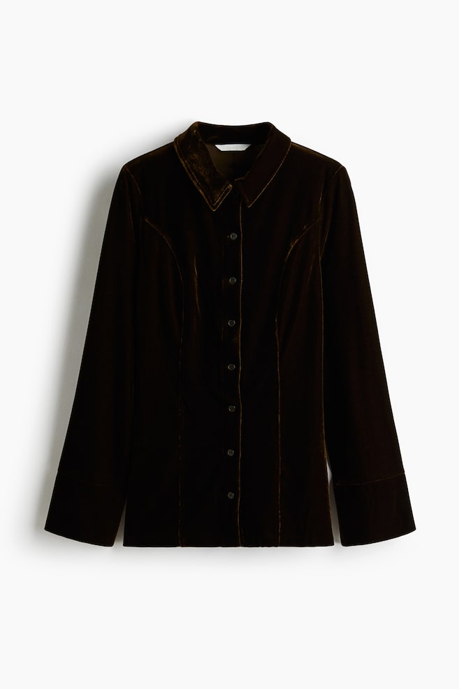 A dark brown velvet shirt is being presented from the front, featuring a classic pointed collar, a full button-down placket, vertical shaping seams on the front, and long sleeves with wide banded cuffs. - 1