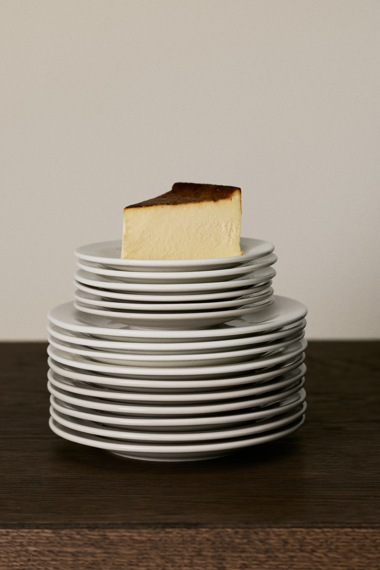 Two round, off-white plates are presented flat, facing upwards. Each plate is designed with a slightly raised rim and a smooth, flat centre. - 1