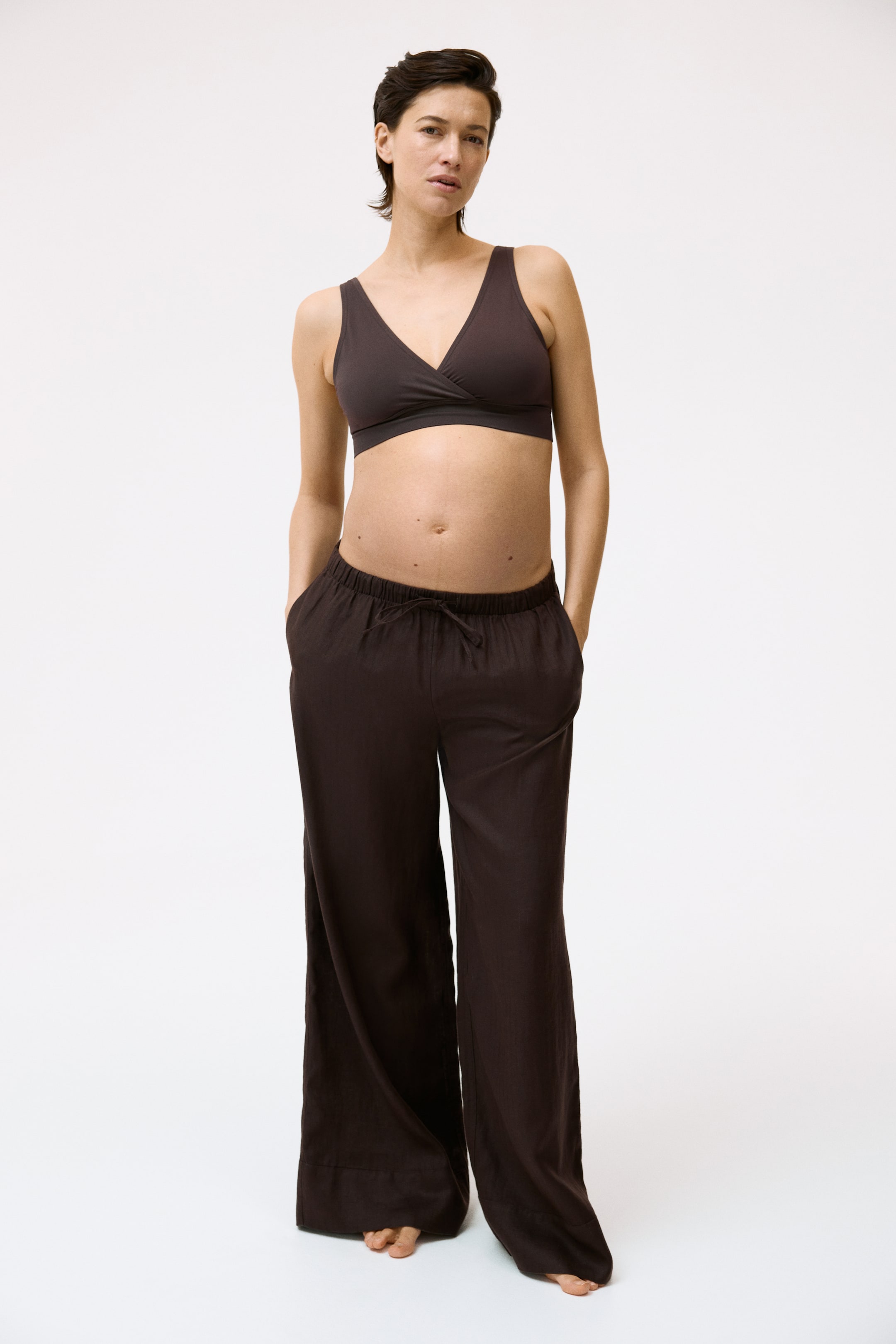 Agrandir l'image: Un bralette cache-cœur marron foncé est doté de larges bretelles et d'une large bande sous la poitrine, assorti à un pantalon large marron foncé conçu avec une taille élastiquée à cordon de serrage et des poches latérales.