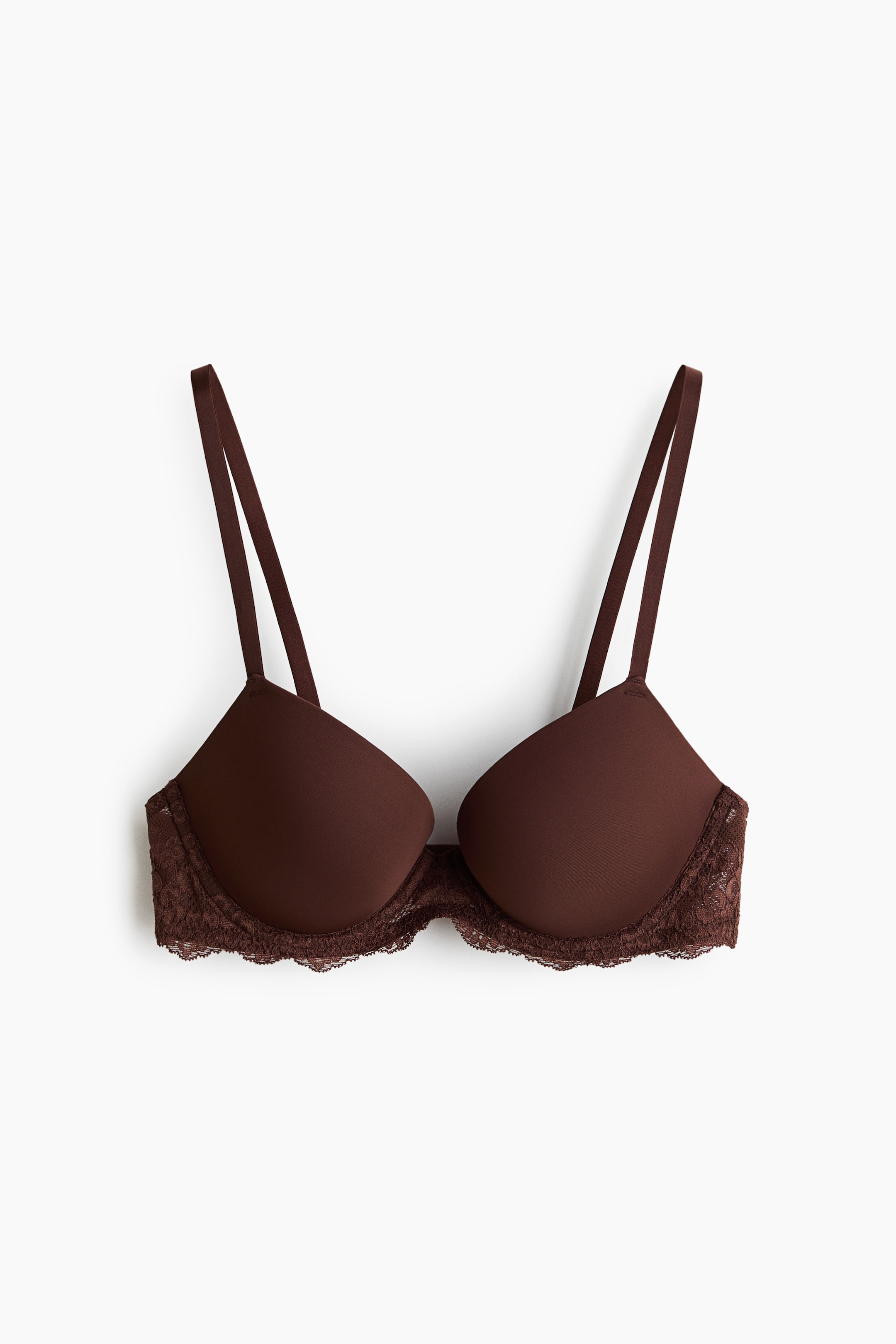 View larger image: A brown push-up bra is displayed from the front, featuring smooth microfiber underwired, padded cups. It showcases adjustable shoulder straps and a scalloped lace trim along its bottom edge.