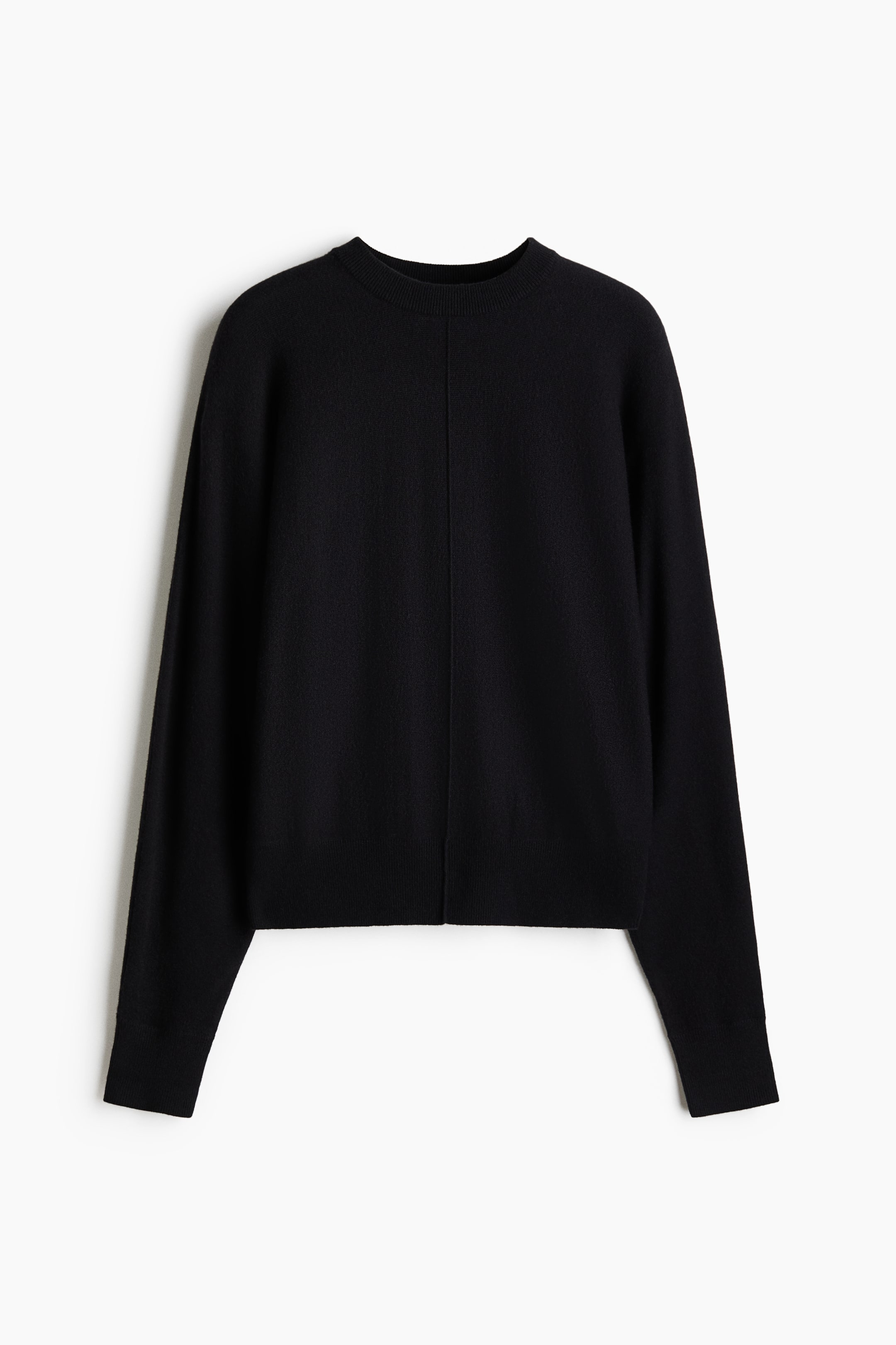 View larger image: A black finely knitted sweater is lying flat, facing forward, showcasing a crew neck and long sleeves with ribbed cuffs. A vertical seam runs down its center front, and a ribbed hem is visible at the bottom.