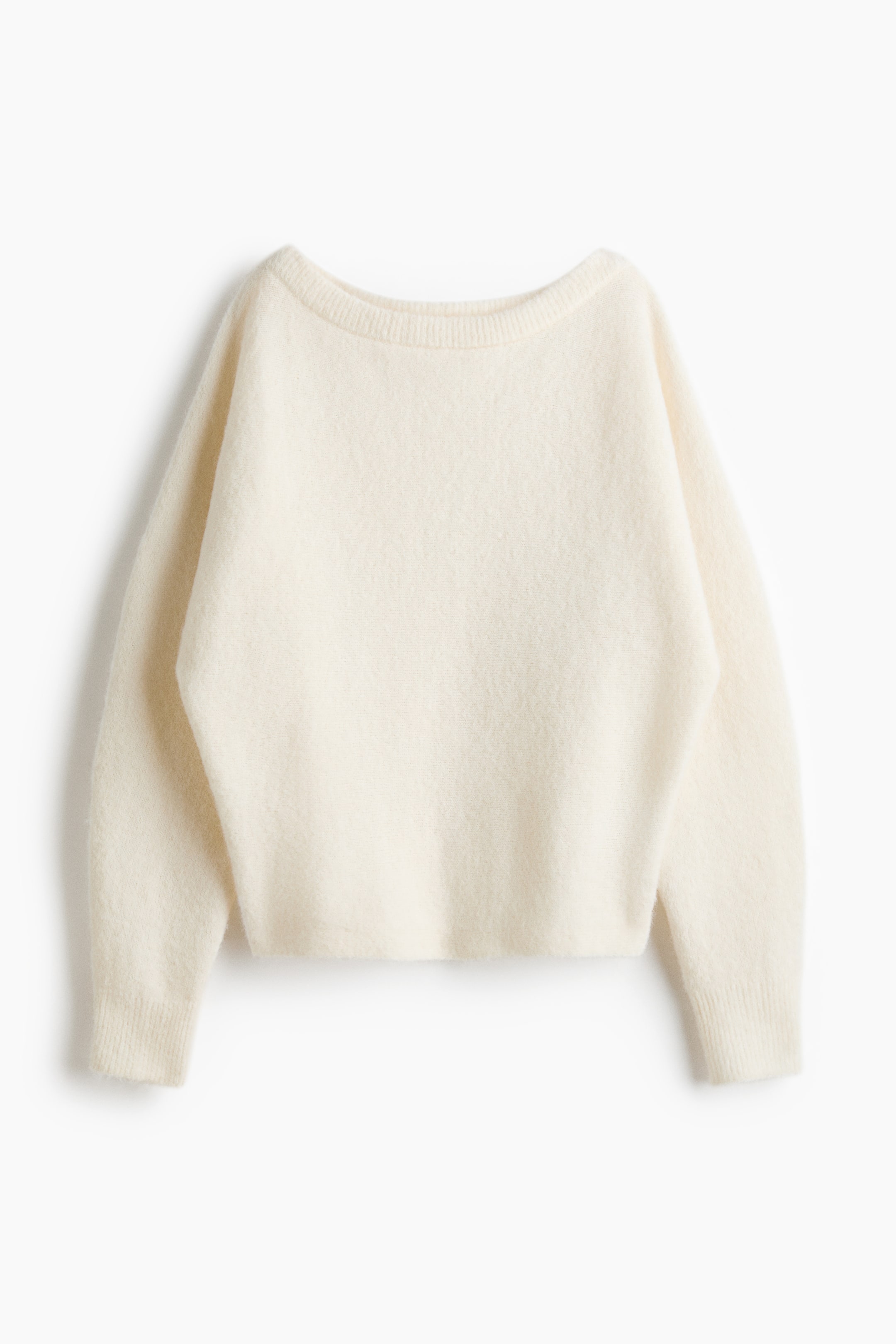 View larger image: A cream-coloured knit sweater is shown from the front, featuring a wide boat neckline, dropped shoulders, and long sleeves with ribbed cuffs. The garment displays a soft, fuzzy texture with a relaxed silhouette.