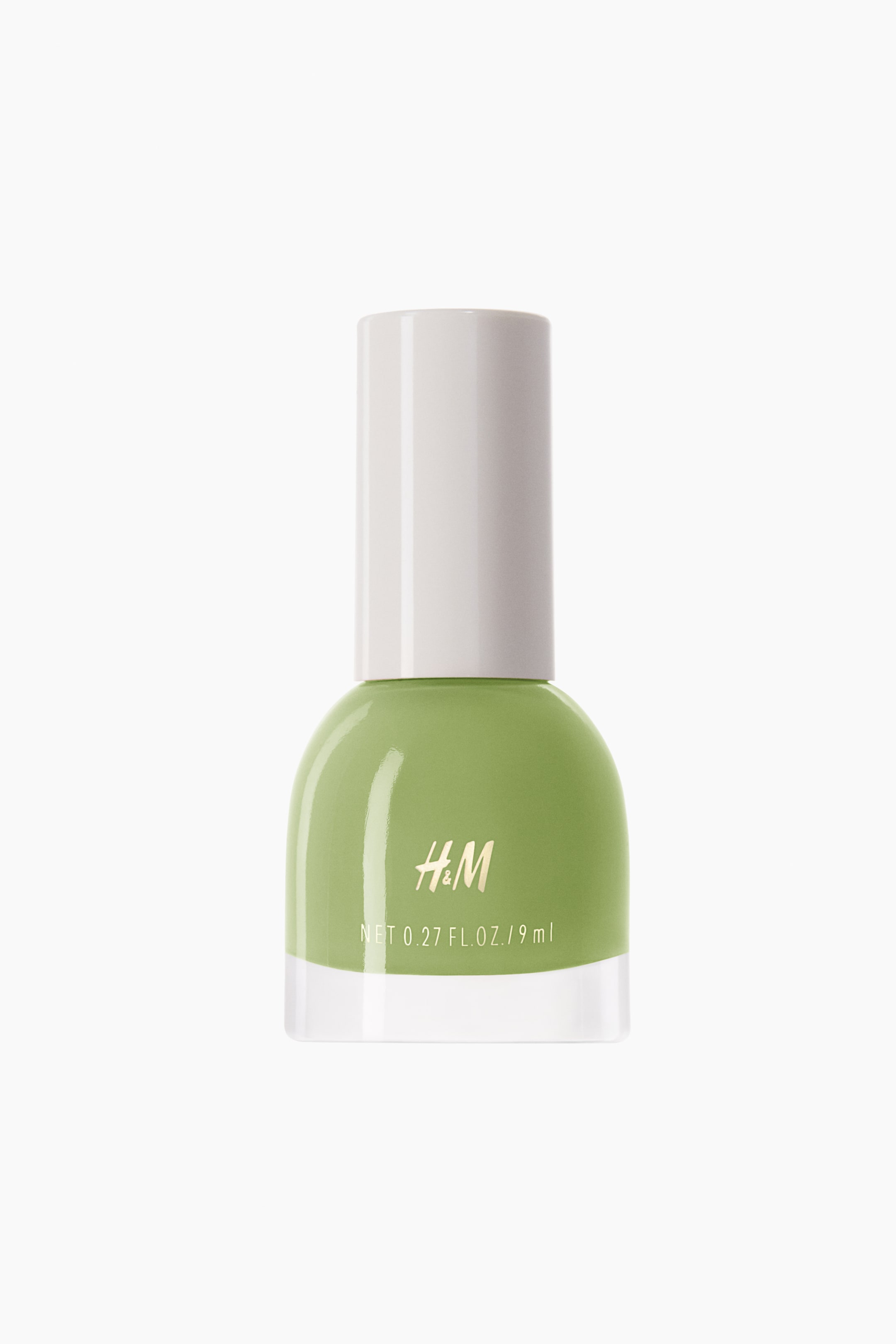 View larger image: The nail polish is presented in a rounded, transparent glass bottle, containing a light green liquid and topped with a white cylindrical cap. The front of the bottle prominently displays the 'H&M' logo along with the net volume.