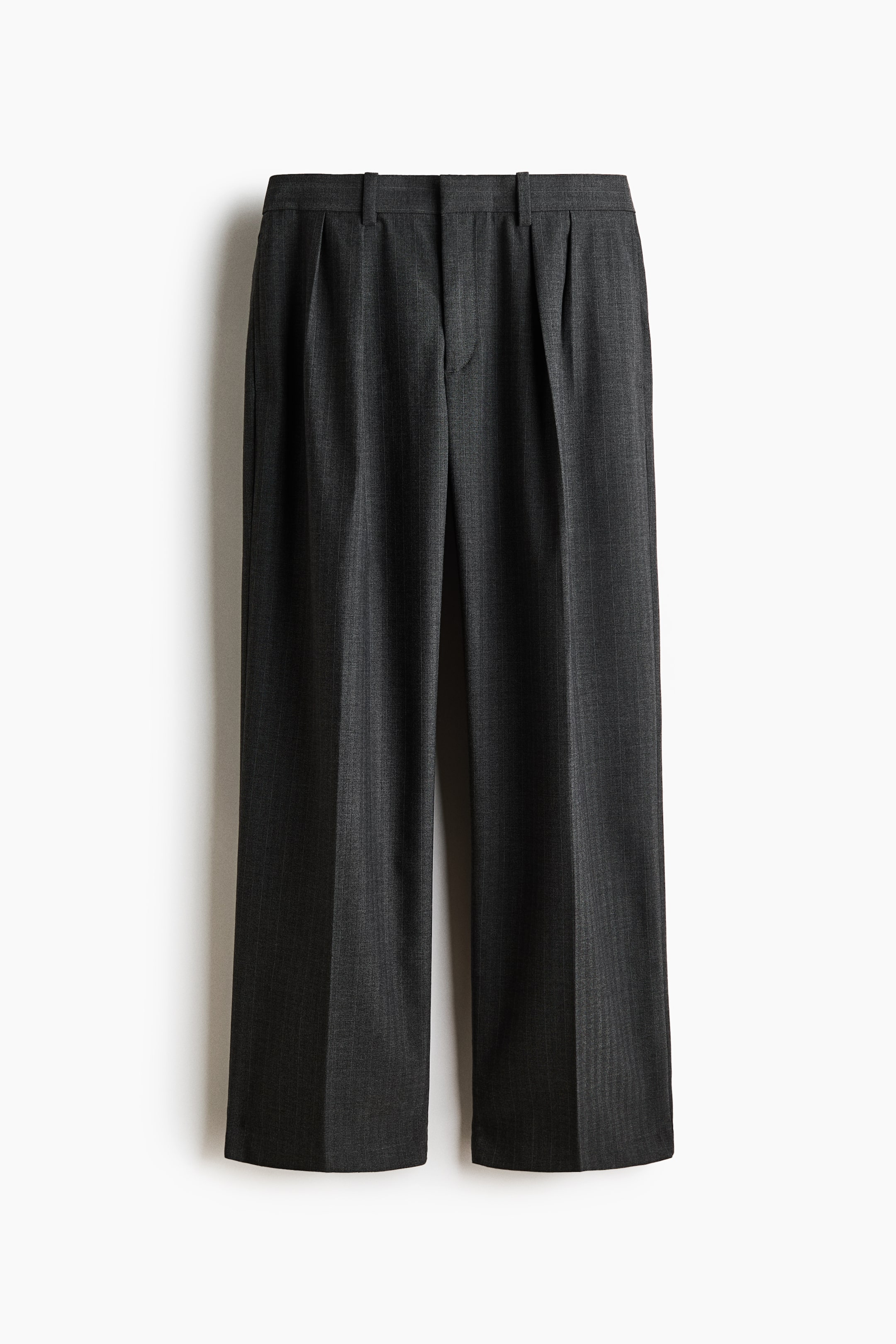 View larger image: A pair of dark grey pinstriped trousers is shown from the front, featuring a flat waistband with belt loops and a concealed fly closure. Double pleats fall from the waistband on each leg, and the wide-cut legs have a prominent centre crease.