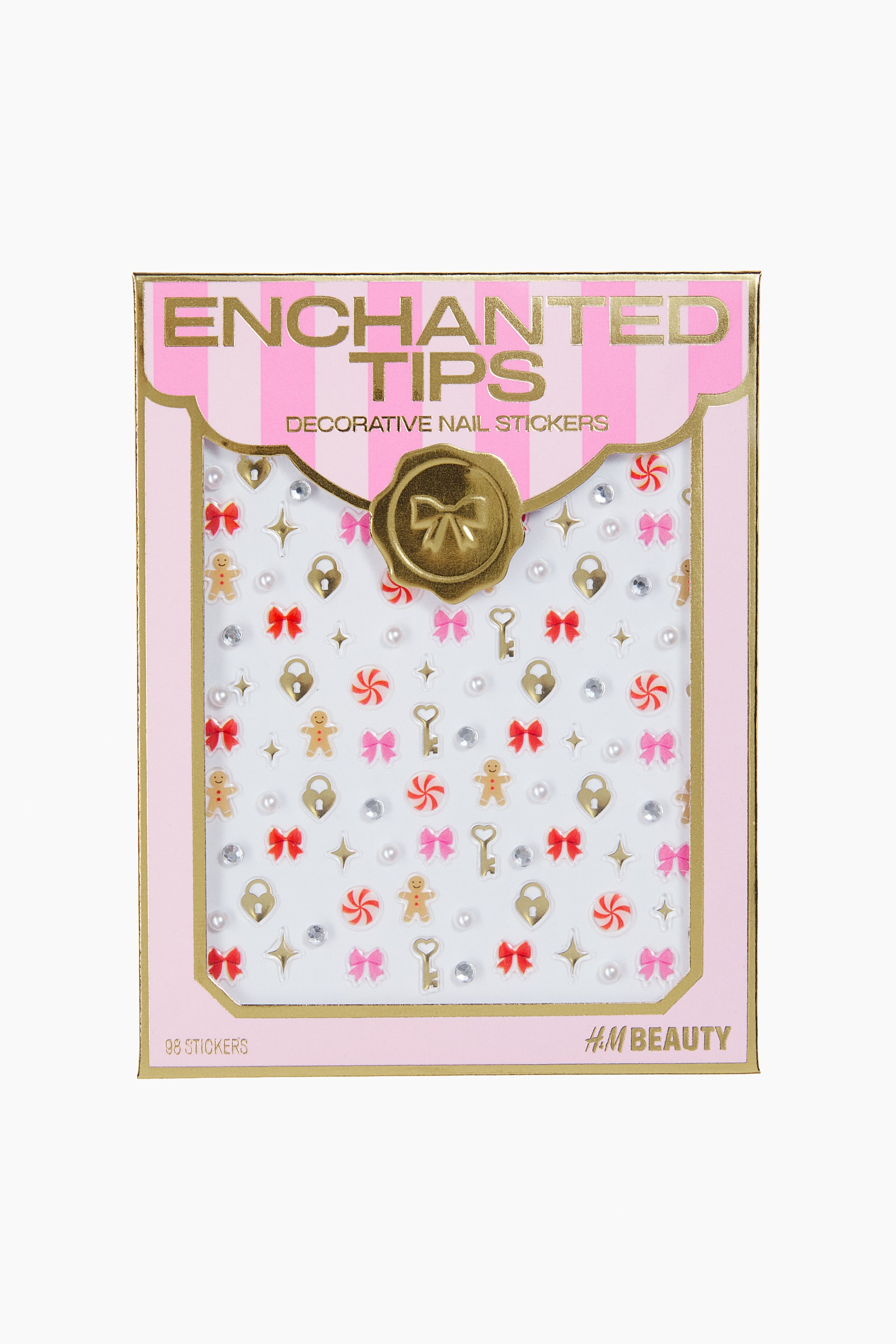 View larger image: A front view showing a set of decorative 3D nail stickers presented in a light pink box with gold-trimmed borders and vertical stripes. The clear window displays a sheet of festive stickers, including small red and pink bows, gingerbread men, gold heart locks, keys, peppermint sweets, and faux pearls.
